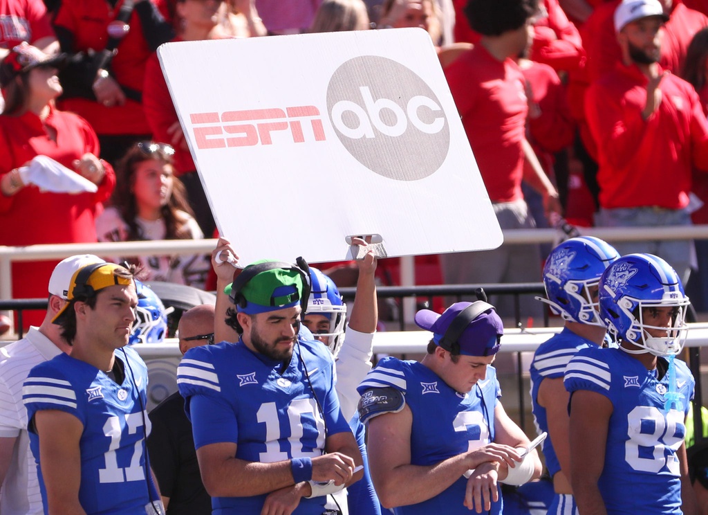 A sign depicting logos of ESPN and ABC is seen on the BYU sideline during a Big 12 Conference football game, Saturday, Nov. 8, 2025, at Jones AT&T Stadium.