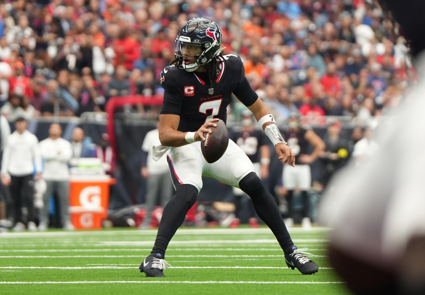 Houston Texans quarterback C.J. Stroud (7) scrambles during the first half against the Denver Broncos at NRG Stadium.
