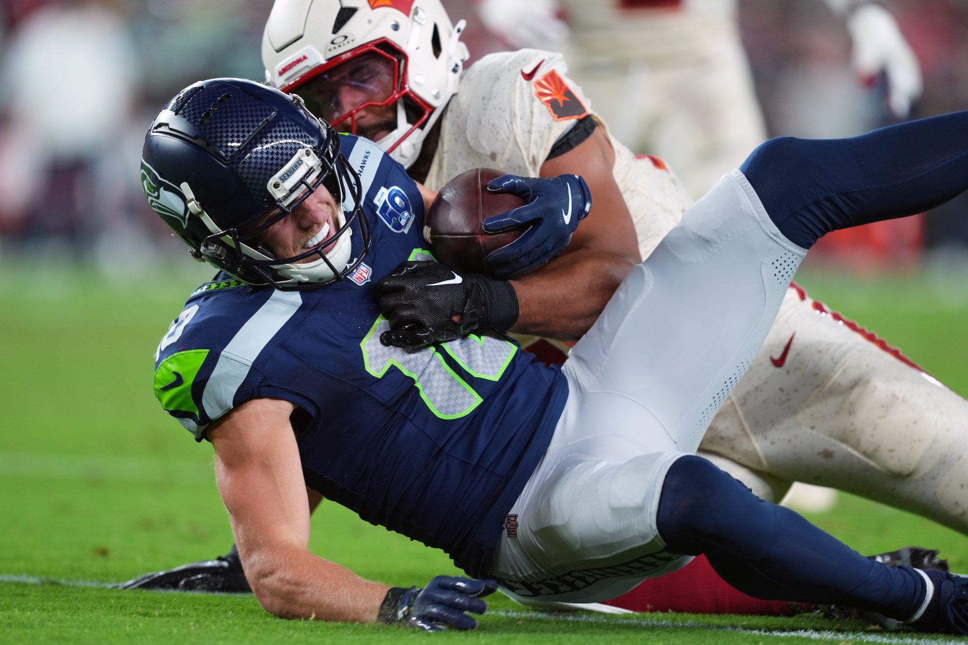 Arizona Cardinals linebacker Zaven Collins (25) tackles Seattle Seahawks wide receiver Cooper Kupp (10) in the third quarter at State Farm Stadium.