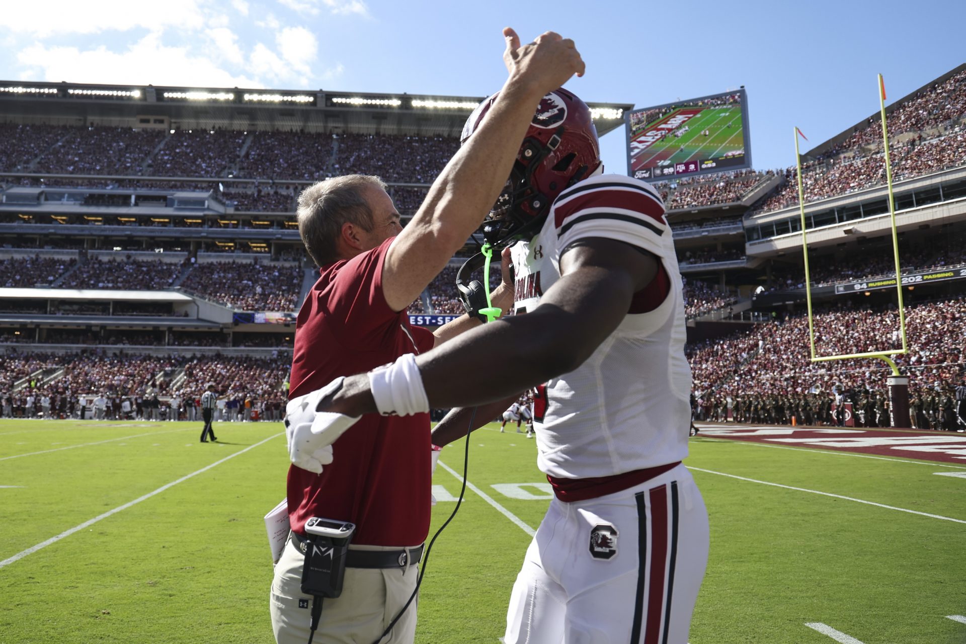 South Carolina Gamecocks wide receiver Nyck Harbor (8) is embraced by head coach Shane Beamer after scoring a touchdown during the second quarter against the Texas A&M Aggies at Kyle Field.
