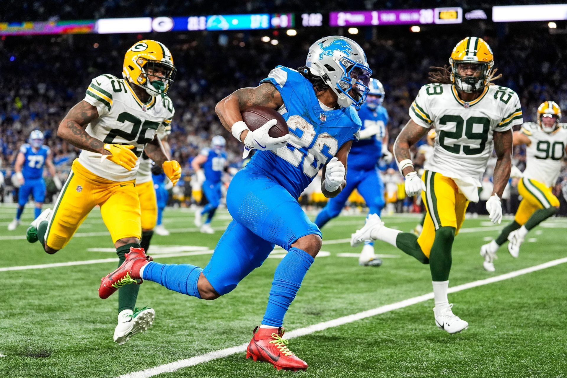 Detroit Lions running back Jahmyr Gibbs runs for a first down against Green Bay Packers safety Xavier McKinney (29) during the second half at Ford Field in Detroit on Thursday, Dec. 5, 2024.