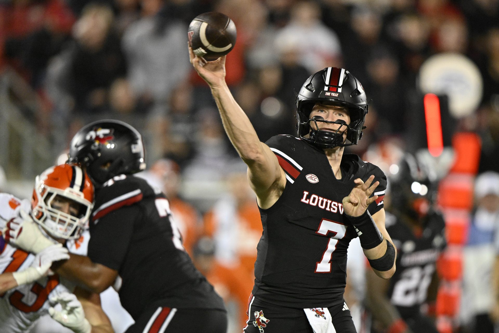 Louisville Cardinals quarterback Miller Moss (7) looks to pass against the Clemson Tigers during the first half at L&N Federal Credit Union Stadium.
