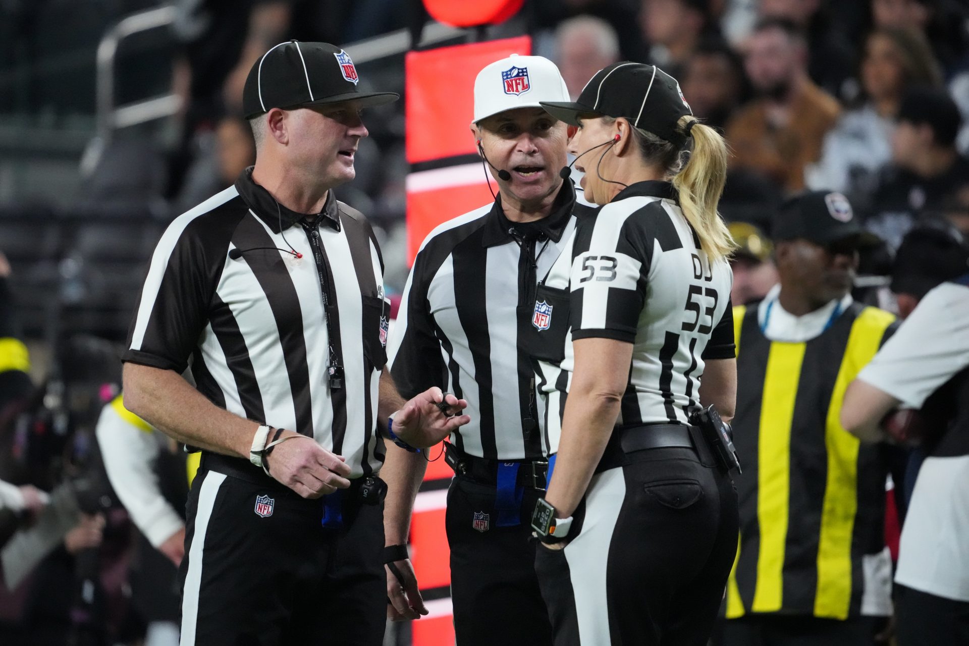 Side judge Chad Hill (125), referee Brad Allen (122) and down judge Sarah Thomas (53) talk between plays during the second half of a game between the Las Vegas Raiders and the Dallas Cowboys  at Allegiant Stadium.