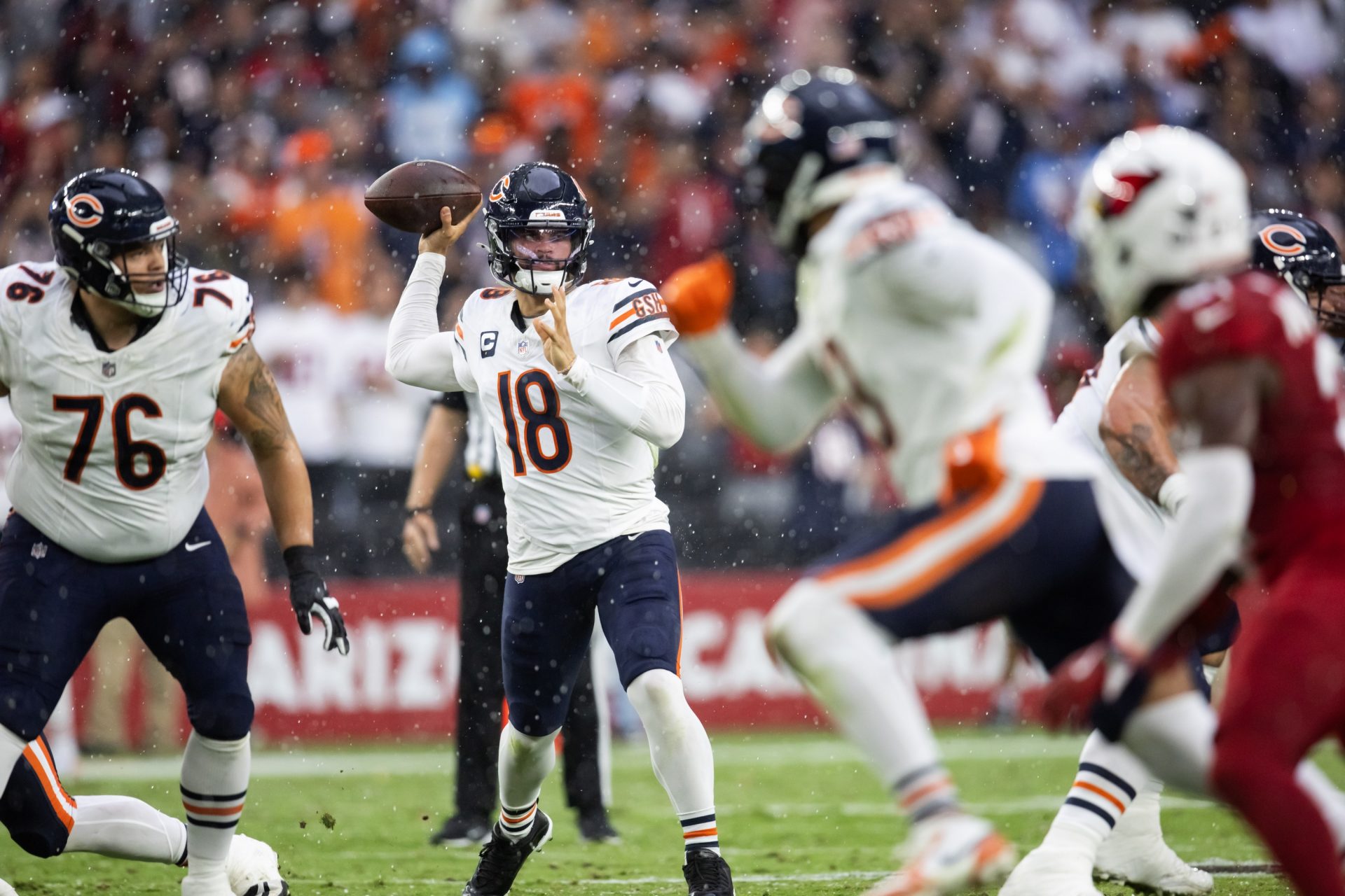 Chicago Bears quarterback Caleb Williams (18) throws a pass as hail and rain fall against the Arizona Cardinals in the first half at State Farm Stadium.