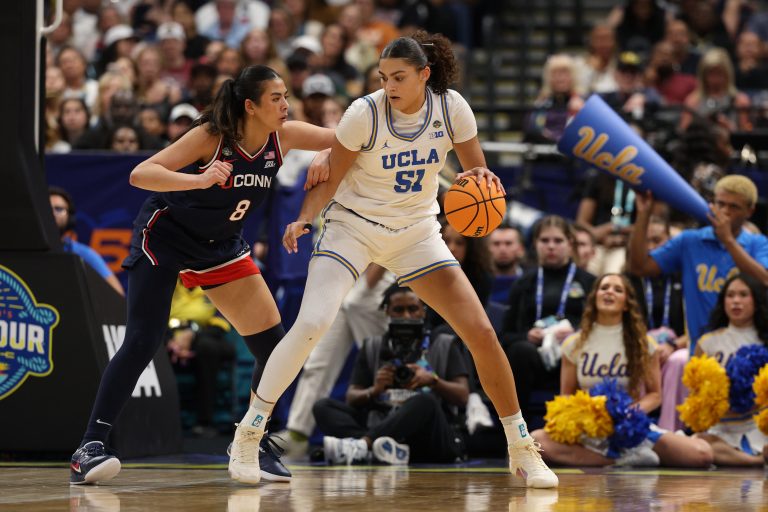 UCLA Bruins center Lauren Betts (51) dribbles against Connecticut Huskies center Jana El Alfy (8) during the third quarter in a semifinal of the women's 2025 NCAA tournament at Amalie Arena.