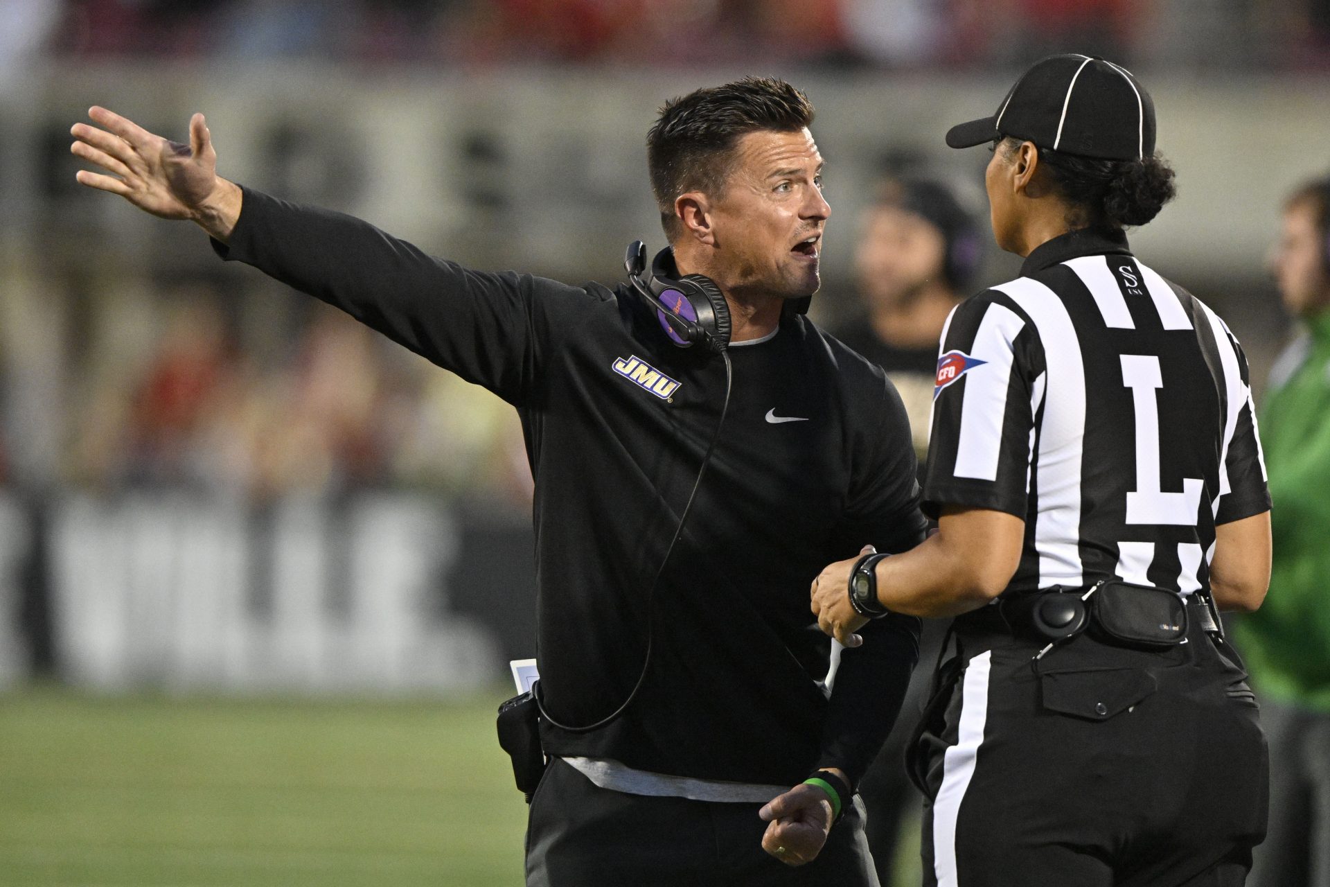 James Madison Dukes head coach Bob Chesney argues a call with an official during the first half against the Louisville Cardinals at L&N Federal Credit Union Stadium.