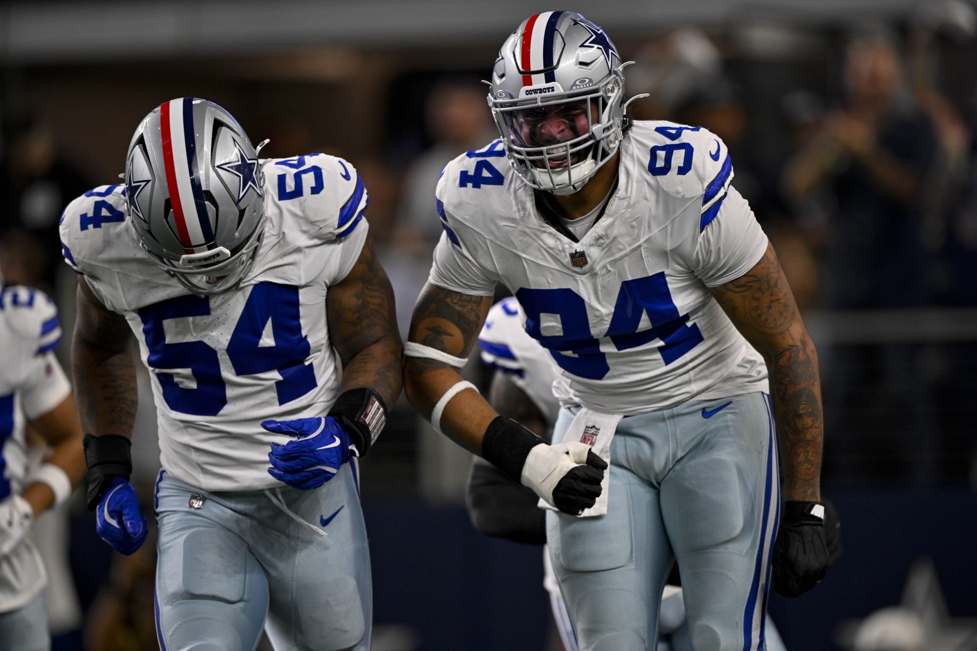 Dallas Cowboys defensive end Marshawn Kneeland (94) and defensive end Sam Williams (54) celebrates after returning a blocked punt for a touchdown during the game between the Dallas Cowboys and the Arizona Cardinals at AT&T Stadium.