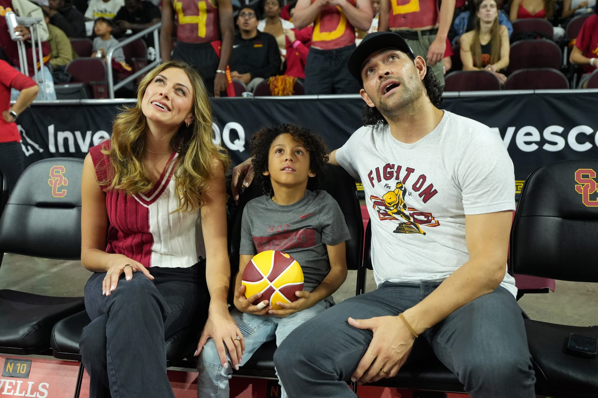Former NFL and USC football player Mark Sanchez (right) and wife American actress Perry Mattfeld (left) with son Daniel Sanchez (center) attend the game between the Southern California Trojans and the UCLA Bruins at the Galen Center.