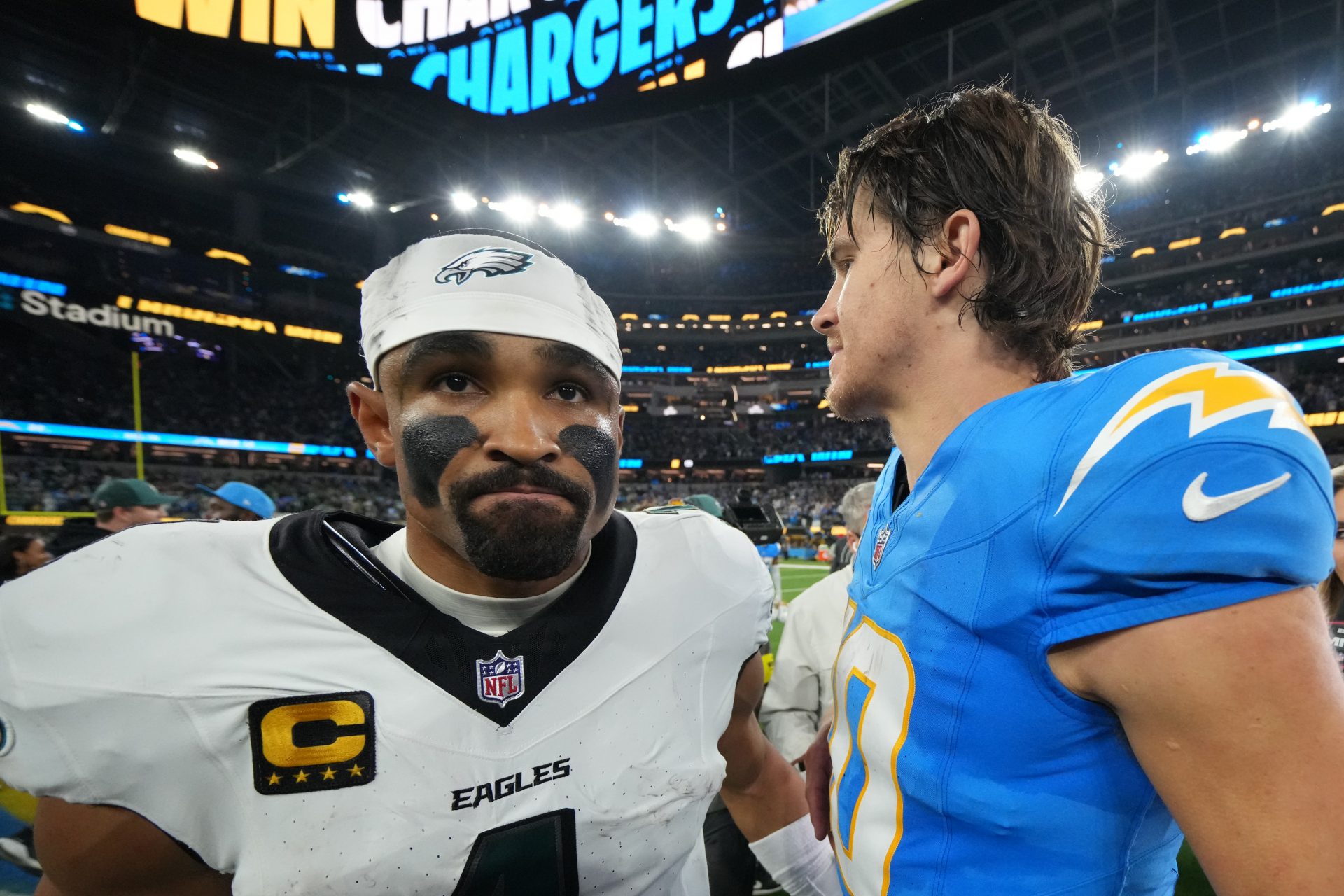 Los Angeles Chargers quarterback Justin Herbert (10) embraces Philadelphia Eagles quarterback Jalen Hurts (1) after the game at SoFi Stadium.