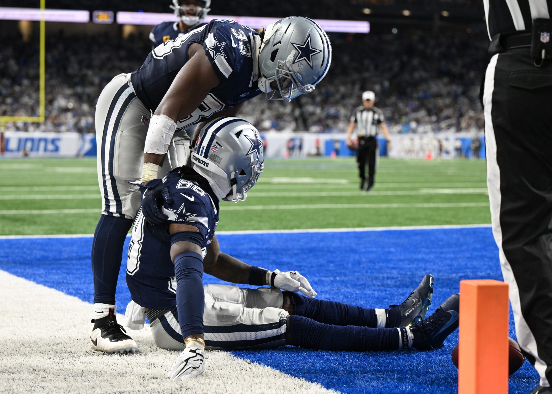 Dallas Cowboys wide receiver CeeDee Lamb (88) is helped by Dallas Cowboys running back Javonte Williams (33) after being injured during the second half against the Detroit Lions at Ford Field.