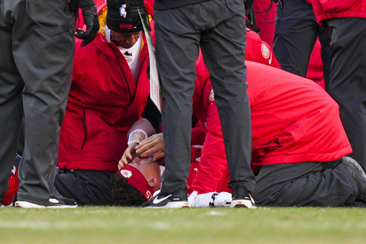 Kansas City Chiefs quarterback Patrick Mahomes (15) is attended to by team medical staff following an injury during the fourth quarter against the Los Angeles Chargers at GEHA Field at Arrowhead Stadium.