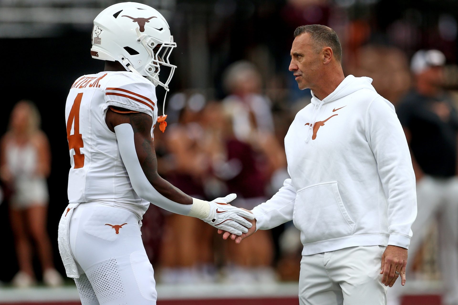 Texas Longhorns head coach Steve Sarkisian (right) talks with Texas Longhorns running back CJ Baxter Jr. (4) during warm ups prior to the game against the Mississippi State Bulldogs at Davis Wade Stadium at Scott Field.
