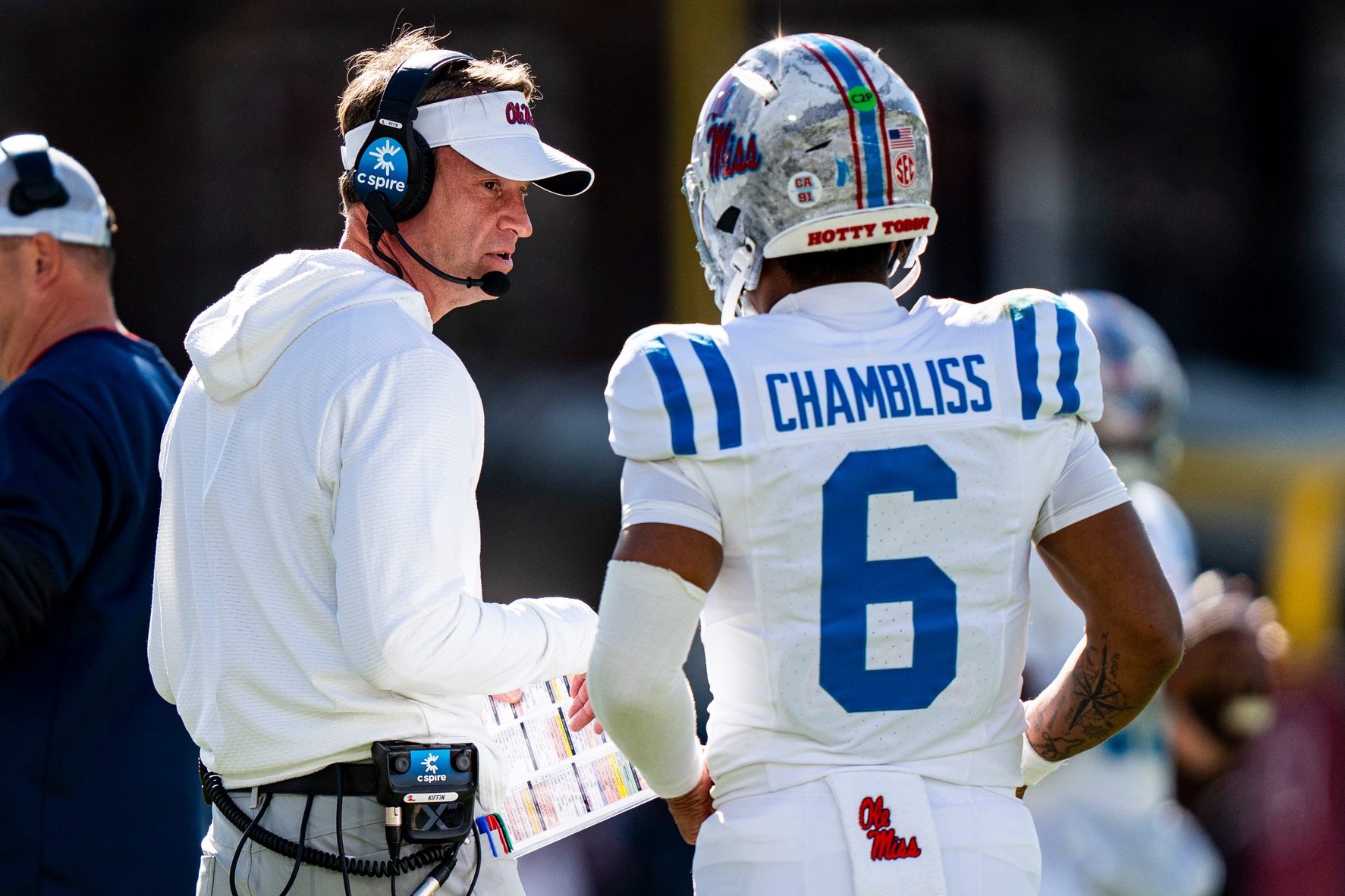 Ole Miss head coach Lane Kiffin talks with quarterback Trinidad Chambliss (6) during a college football game between Mississippi State and Ole Miss at Davis Wade Stadium in Starkville, Miss., on Friday, Nov. 28, 2025. Ole Miss defeated Mississippi State 38-19 in the Egg Bowl.