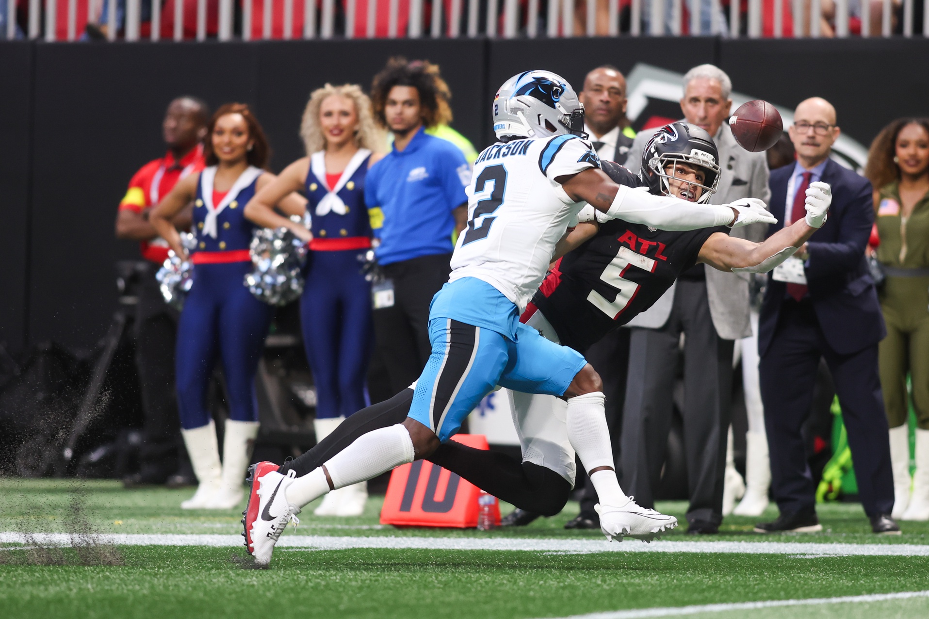 Atlanta Falcons wide receiver Drake London (5) reaches for a pass while defended by Carolina Panthers cornerback Mike Jackson (2) in the fourth quarter at Mercedes-Benz Stadium.
