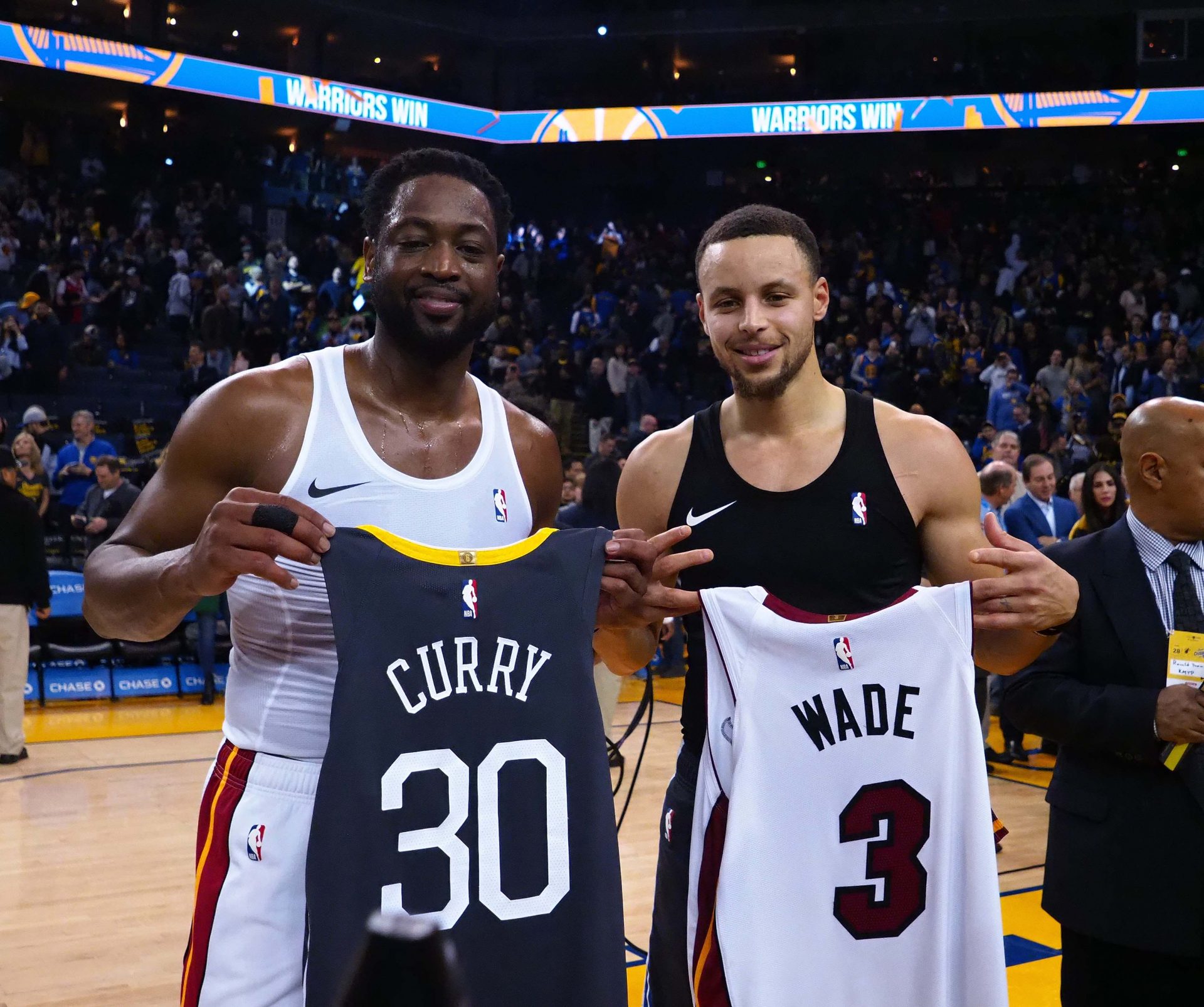 Miami Heat guard Dwyane Wade (3) and Golden State Warriors guard Stephen Curry (30) exchange jerseys after the game at Oracle Arena.