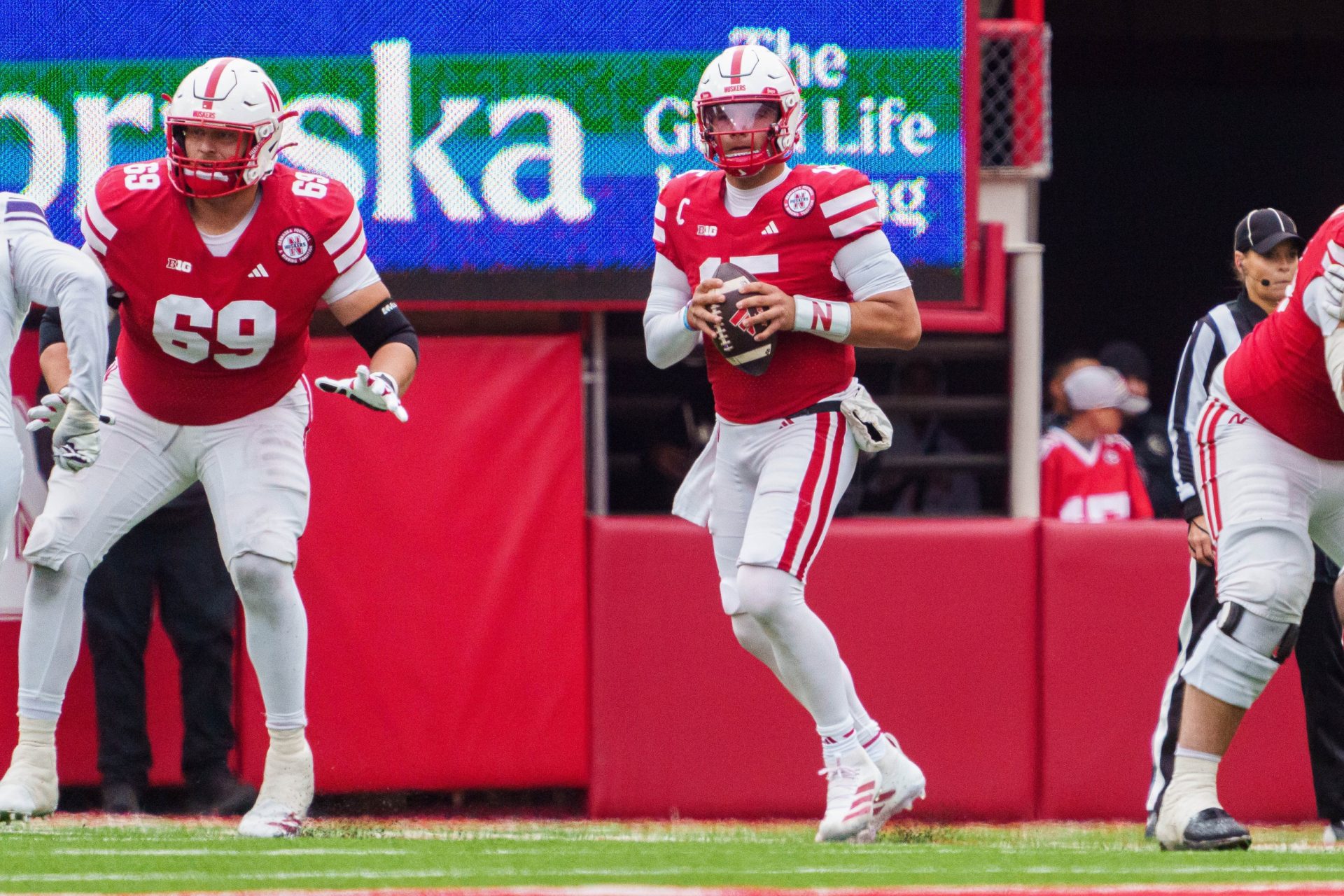 Nebraska Cornhuskers quarterback Dylan Raiola (15) looks to throw a pass and offensive lineman Turner Corcoran (69) blocks against the Northwestern Wildcats during the third quarter at Memorial Stadium.