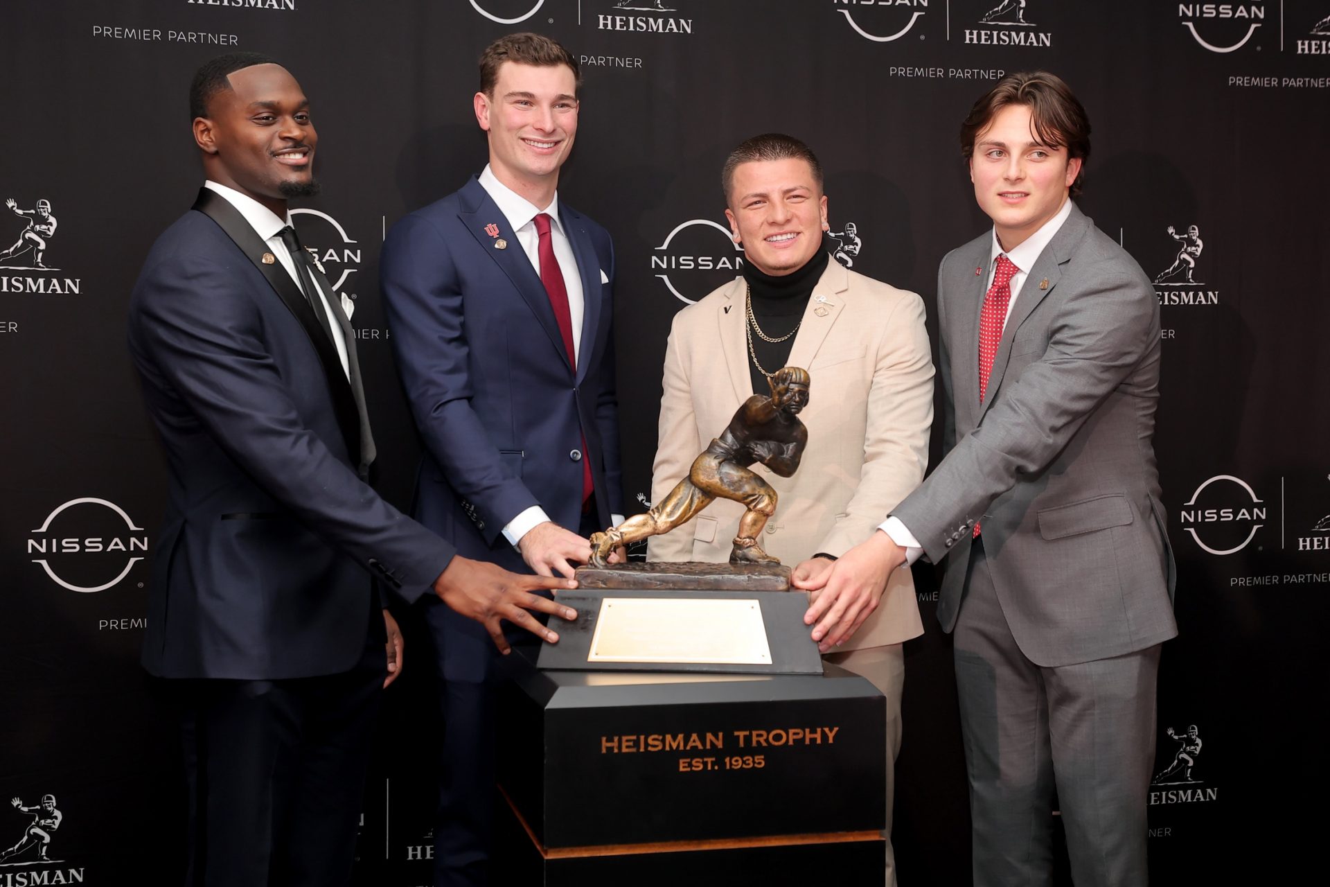 Notre Dame Fighting Irish running back Jeremiyah Love (left to right) and Indiana Hoosiers quarterback Fernando Mendoza and Vanderbilt Commodores quarterback Diego Pavia and Ohio State Buckeyes quarterback Julian Sayin pose with the Heisman trophy during a press conference at the New York Marriott Marquis.