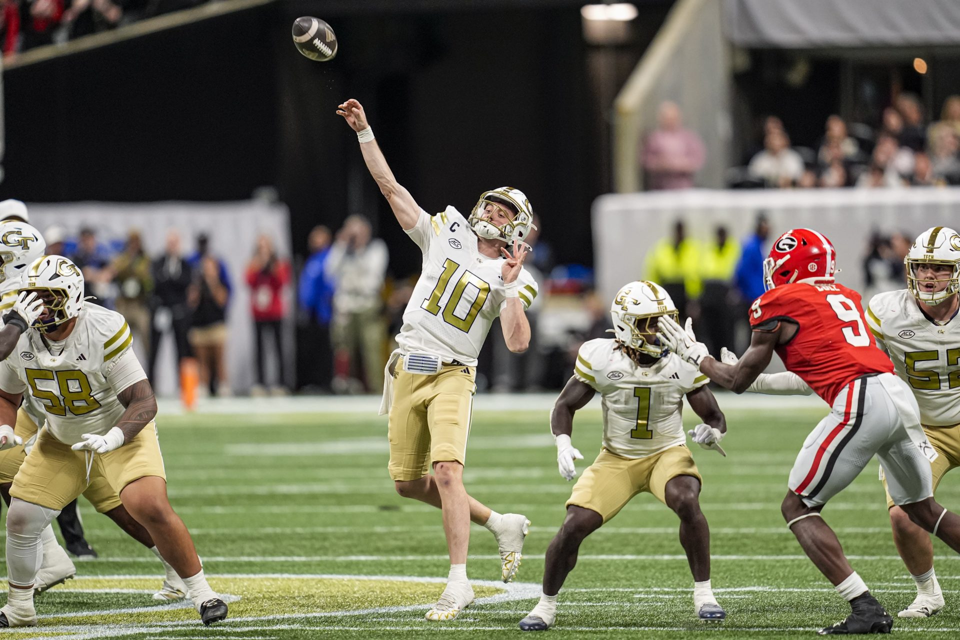 Georgia Tech Yellow Jackets quarterback Haynes King (10) throws a last chance pass to the end zone against the Georgia Bulldogs during the second half at Mercedes-Benz Stadium.