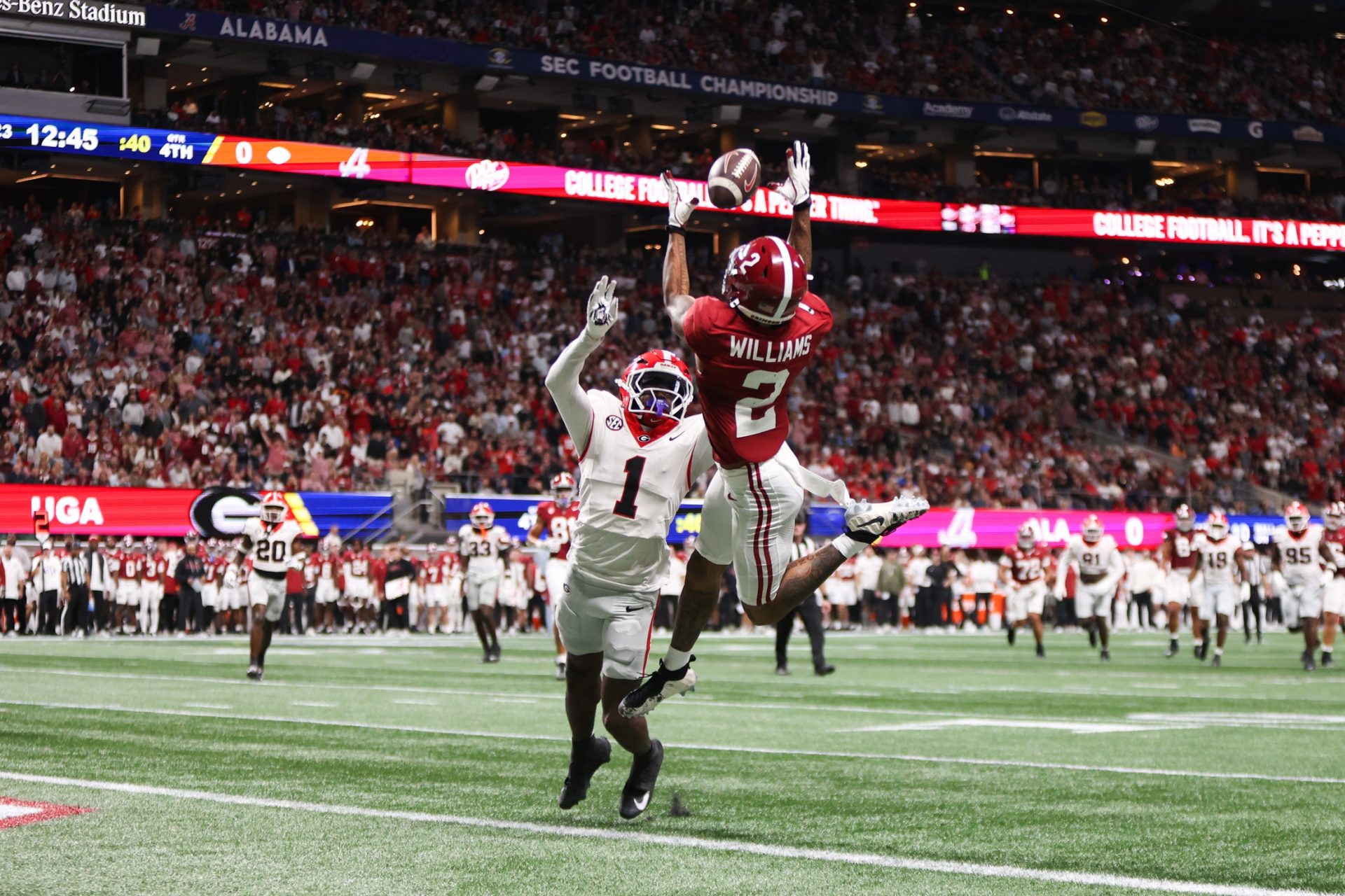 Alabama Crimson Tide wide receiver Ryan Williams (2) attempts to make a catch as Georgia Bulldogs defensive back Ellis Robinson IV (1) defends during the fourth quarter during the 2025 SEC Championship game at Mercedes-Benz Stadium.