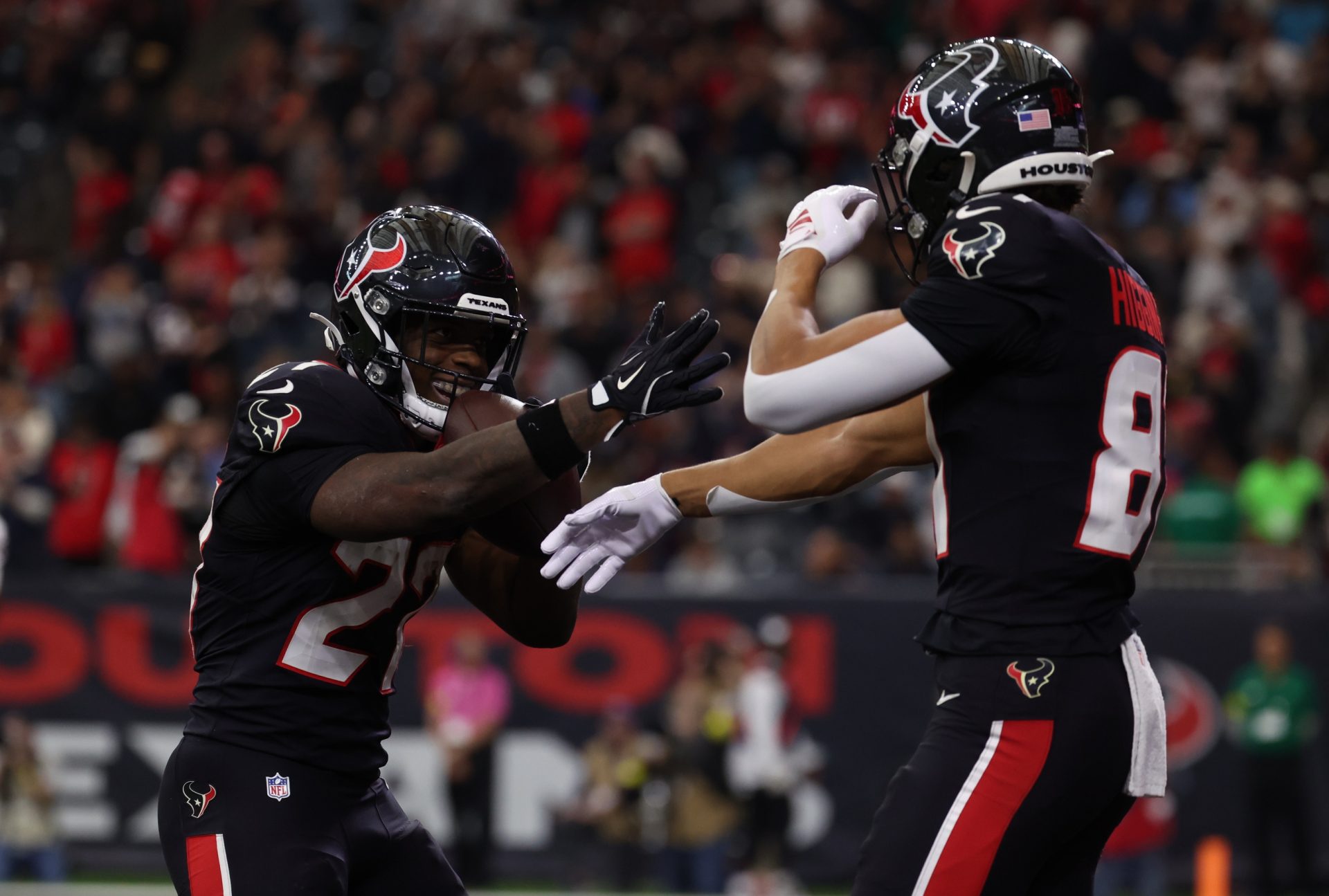 Houston Texans running back Woody Marks (27) and wide receiver Jayden Higgins (81) celebrate a touchdown during the first quarter against the Arizona Cardinals at NRG Stadium.