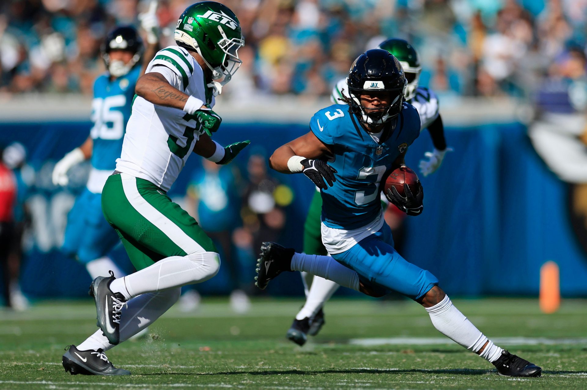 Jacksonville Jaguars wide receiver Jakobi Meyers (3) rushes for yards against New York Jets cornerback Qwan'Tez Stiggers (37) during the first quarter of an NFL football matchup at EverBank Stadium, Sunday, Dec. 14, 2025, in Jacksonville, Fla. [Corey Perrine/Florida Times-Union]