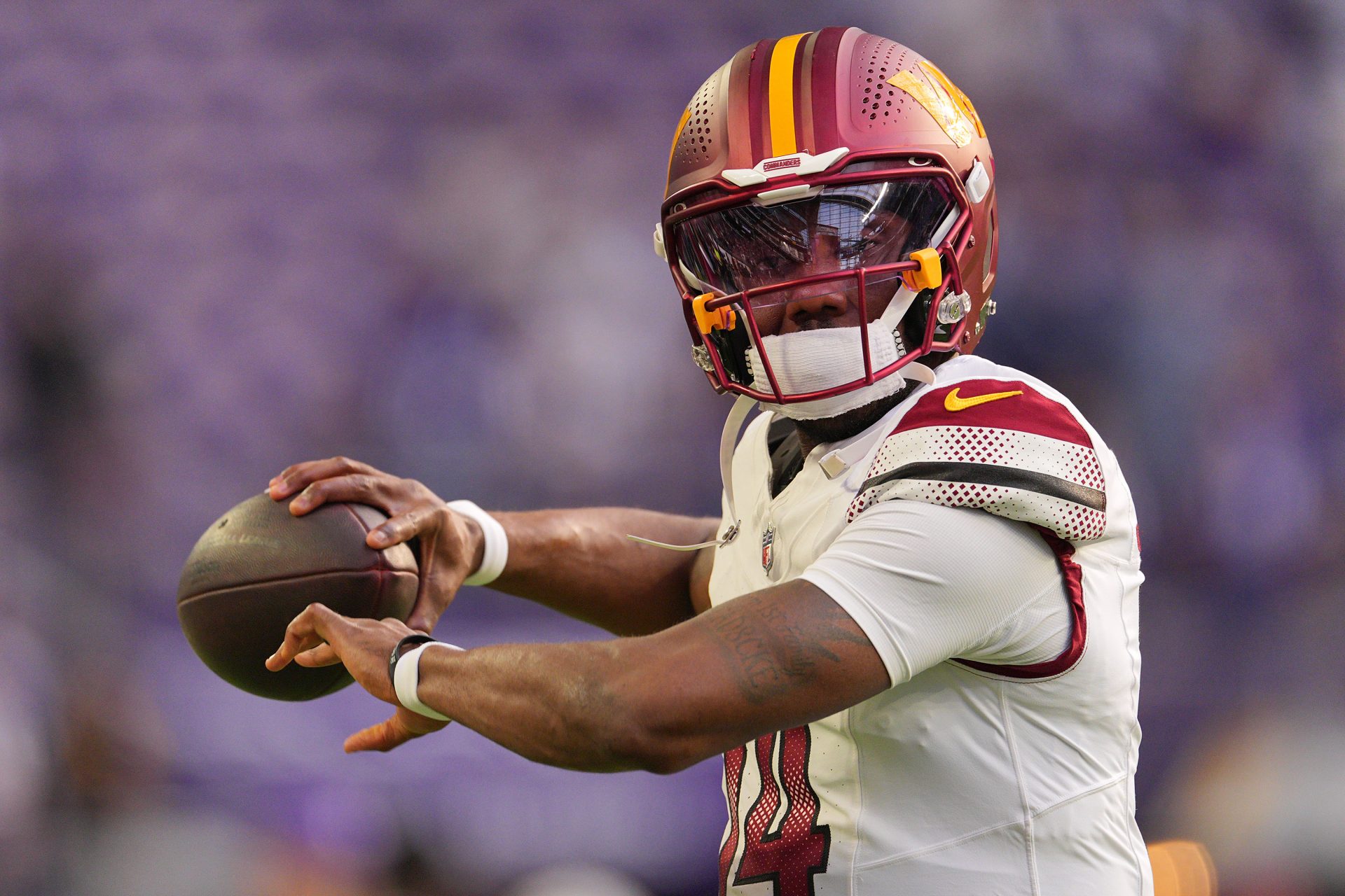 Washington Commanders quarterback Josh Johnson (14) practices before the game at U.S. Bank Stadium.