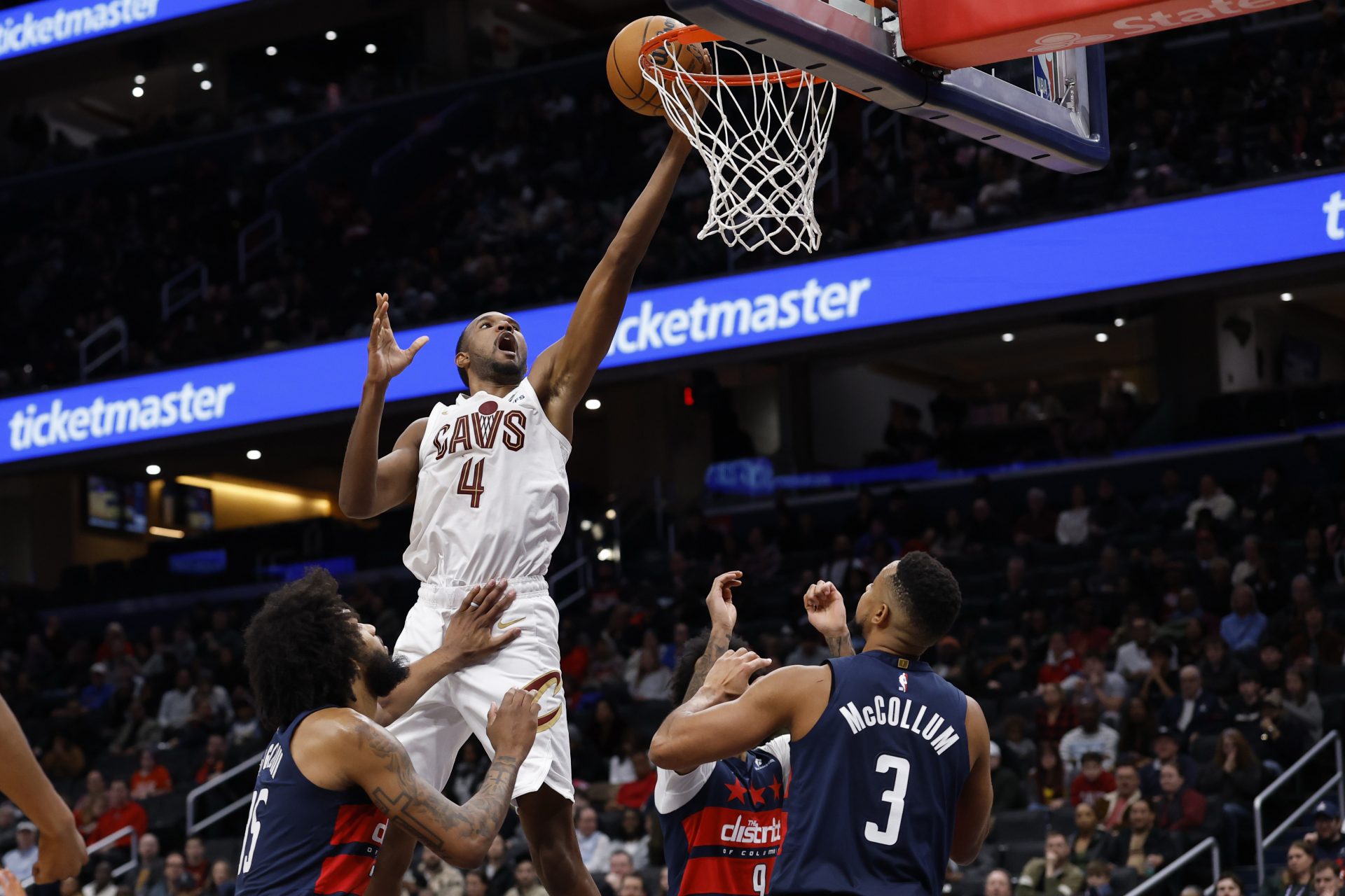 Cleveland Cavaliers center Evan Mobley (4) shoots the ball over Washington Wizards guard CJ McCollum (3) and Wizards forward Marvin Bagley III (35) in the second half at Capital One Arena.
