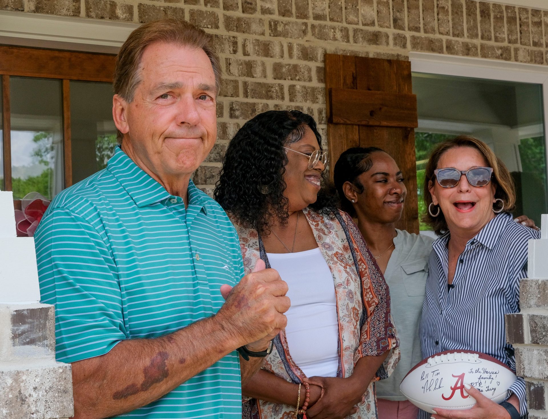 Nick and Terry Saban help dedicate the 20th house funded by the Nick's Kids Foundation for Habitat for Humanity Friday, June 2, 2023, on Elm Street in Tuscaloosa. Nick Saban gets a smile from his wife and new homeowner Richelle Harris as he talks about how Miss Terry changed the rules in order for NickÕs Kids to be able to build more homes.