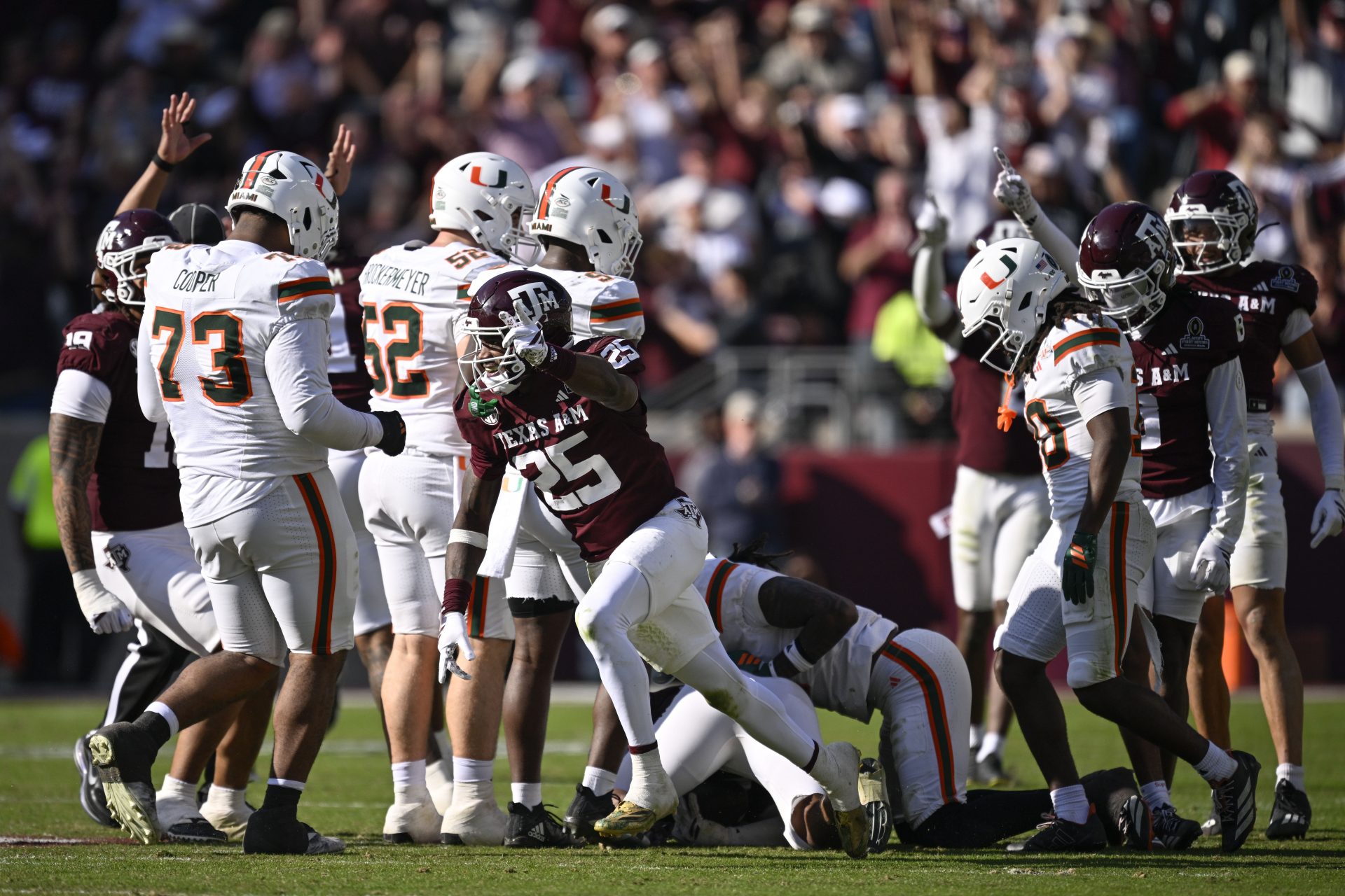 Texas A&M Aggies safety Dalton Brooks (25) reacts after stripping the ball from Miami Hurricanes wide receiver Malachi Toney (10) during the second half of the first round game of the CFP National Playoff at Kyle Field.