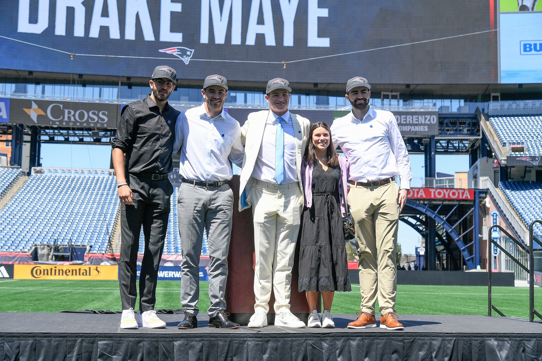 New England Patriots number one draft pick quarterback Drake Maye (C) introduces (L-R: Beau, Cole, Luke) and his girlfriend since 7th grade (Ann Michael) on the game field at Gillette Stadium.