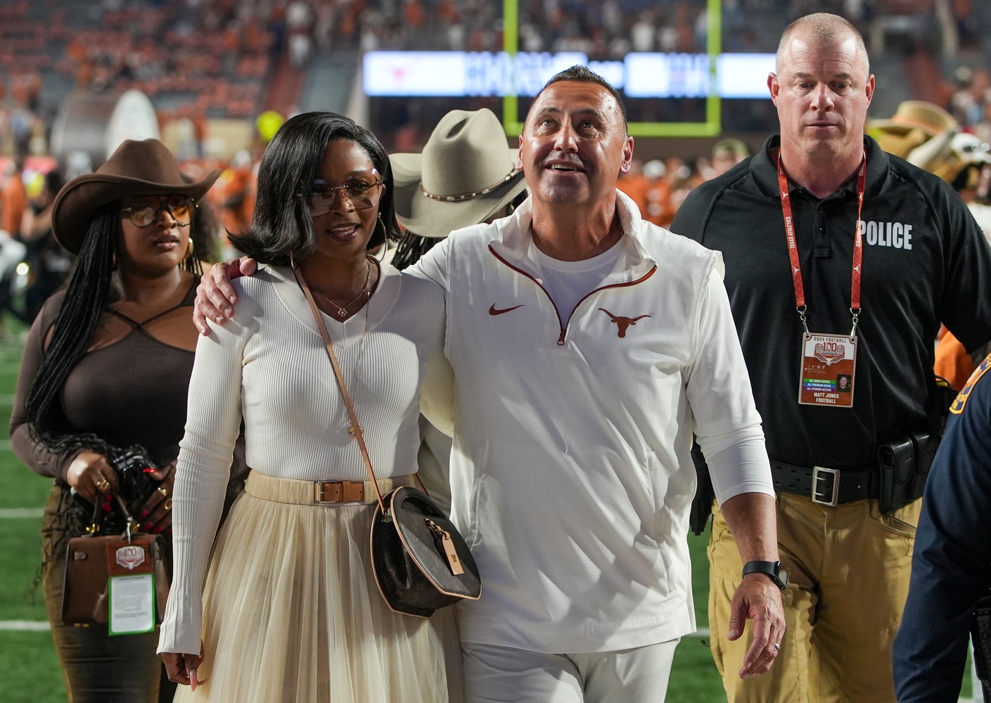 Texas Longhorns head coach Steve Sarkisian and his wife Loreal Sarkisian walk off the field after defeating the Kentucky Wildcats at Darrell K Royal Texas Memorial Stadium.