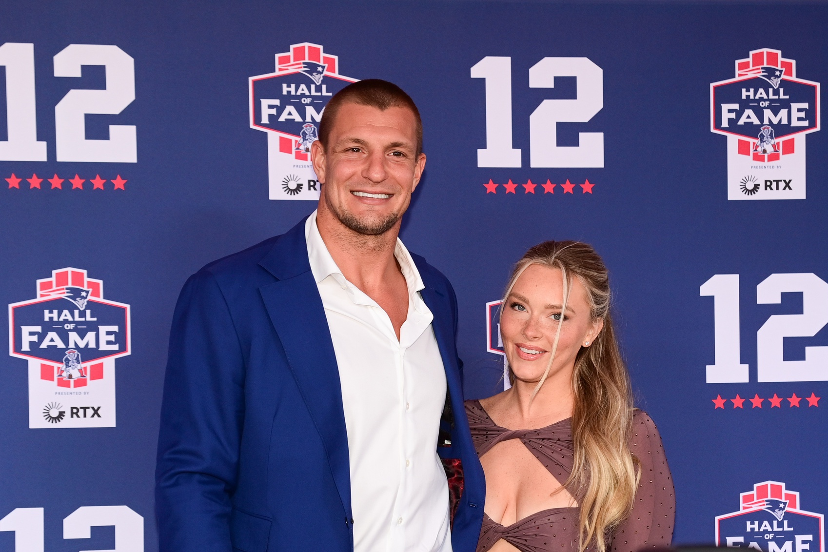 Retired NFL tight end Rob Gronkowski poses for photos with his girlfriend Camille Kostek during the New England Patriots Hall of Fame induction Ceremony for Tom Brady