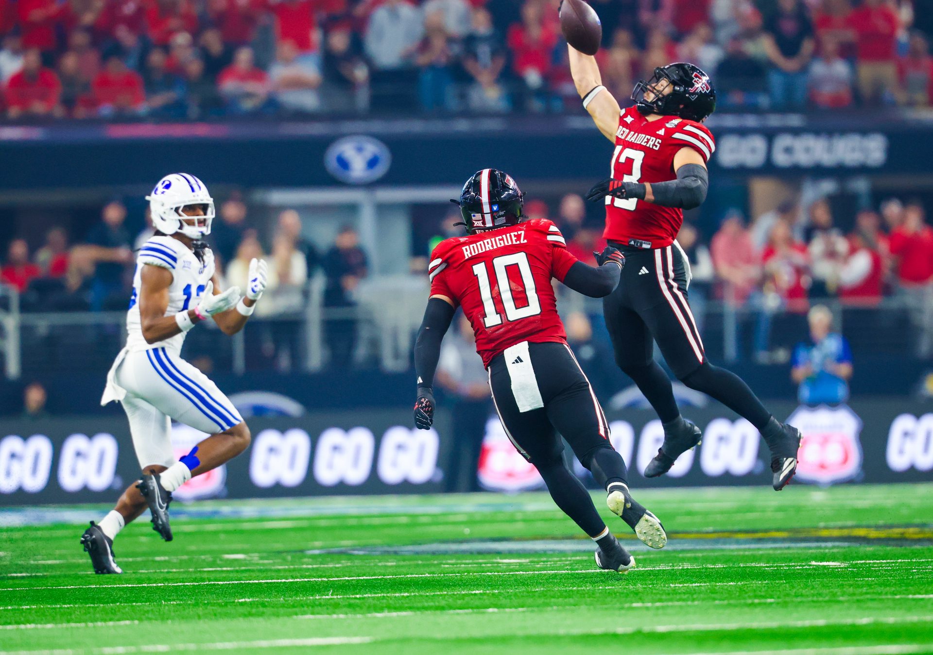 Texas Tech Red Raiders linebacker Ben Roberts (13) makes an interception intended for BYU Cougars wide receiver Jojo Phillips (13) during the second half at AT&T Stadium.