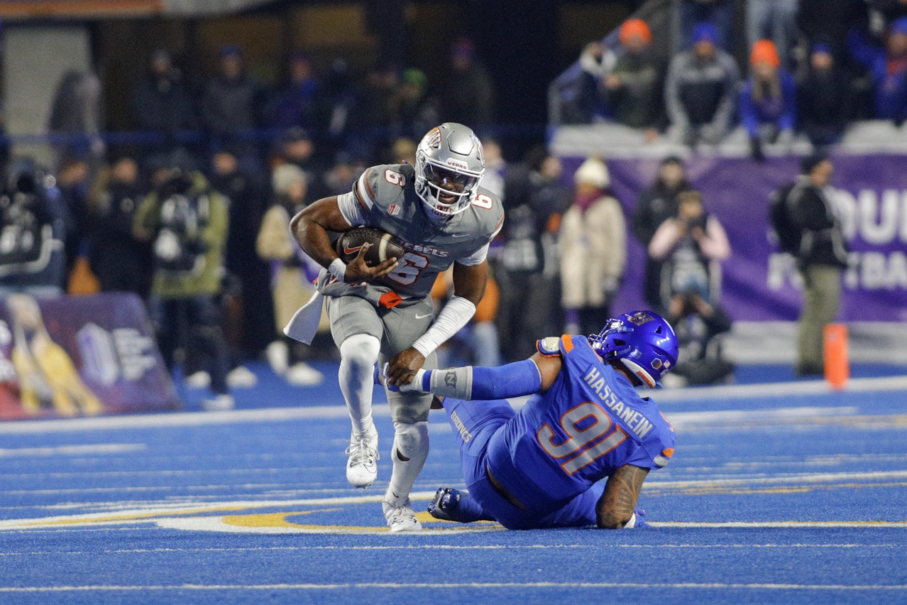 UNLV Rebels quarterback Hajj-Malik Williams (6) breaks the tackle of Boise State Broncos defensive end Ahmed Hassanein (91) during the second half  at Albertsons Stadium. Boise State beats  UNLV 21-7.