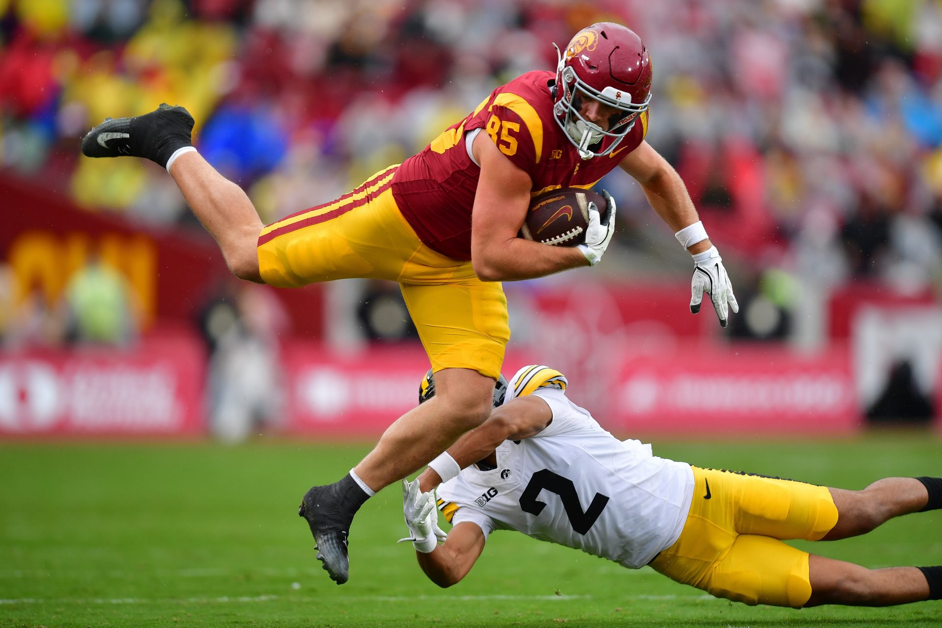 Southern California Trojans tight end Walker Lyons (85) runs the ball against Iowa Hawkeyes defensive back TJ Hall (2) during the first half at the Los Angeles Memorial Coliseum.