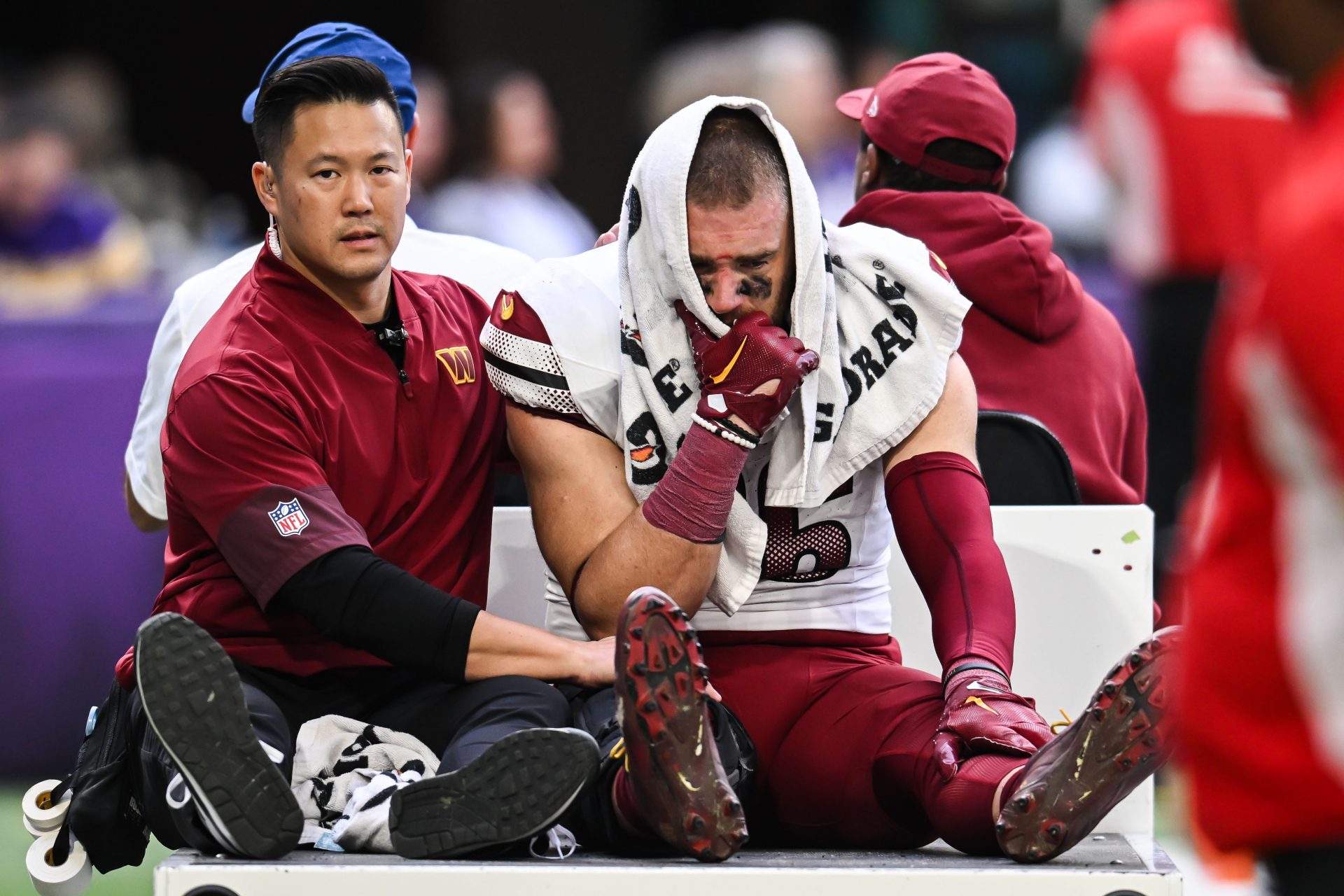 Washington Commanders tight end Zach Ertz (86) is carted off the field after an injury during the second half at U.S. Bank Stadium.