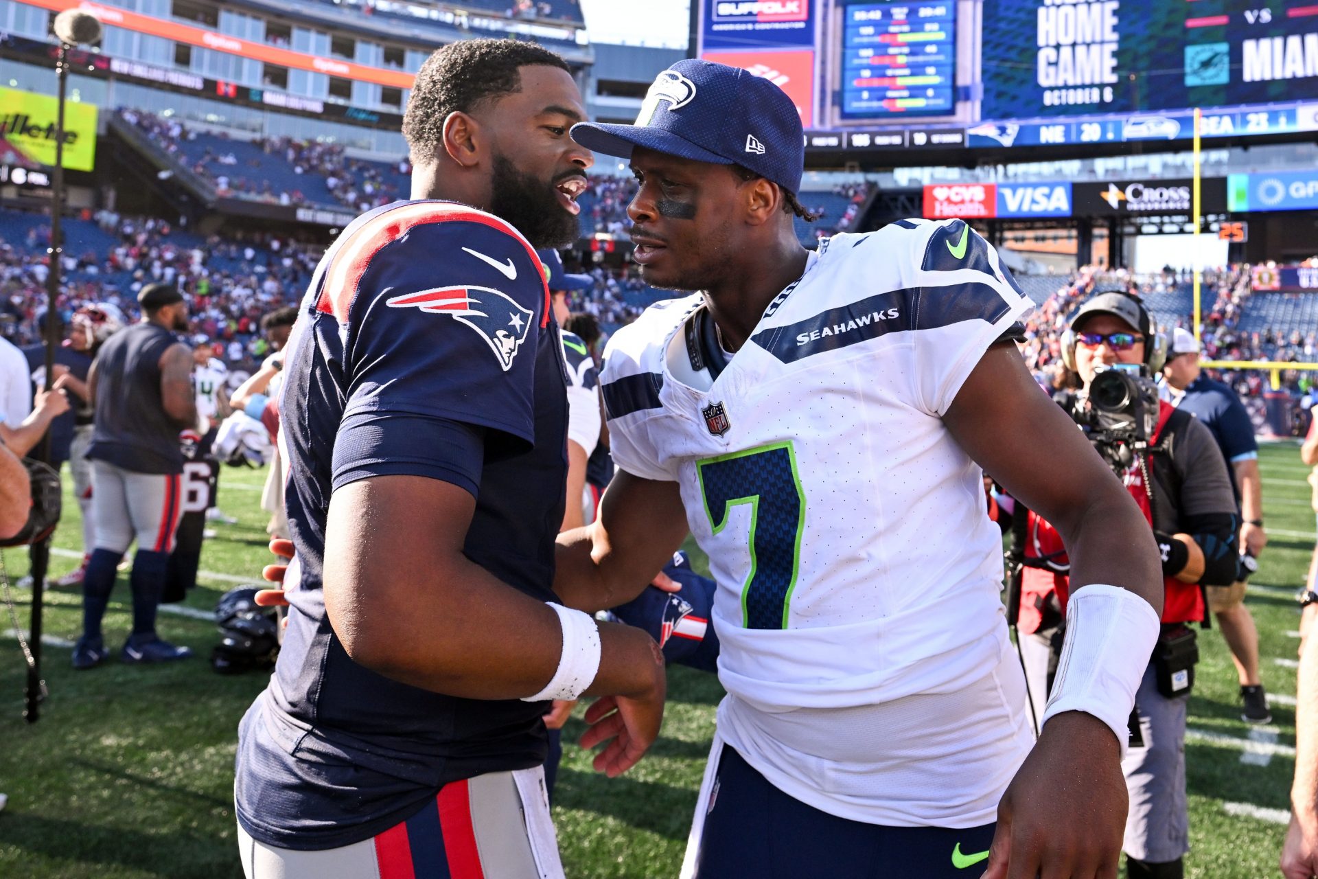 New England Patriots quarterback Jacoby Brissett (7) talks with Seattle Seahawks quarterback Geno Smith (7) after a game  at Gillette Stadium.
