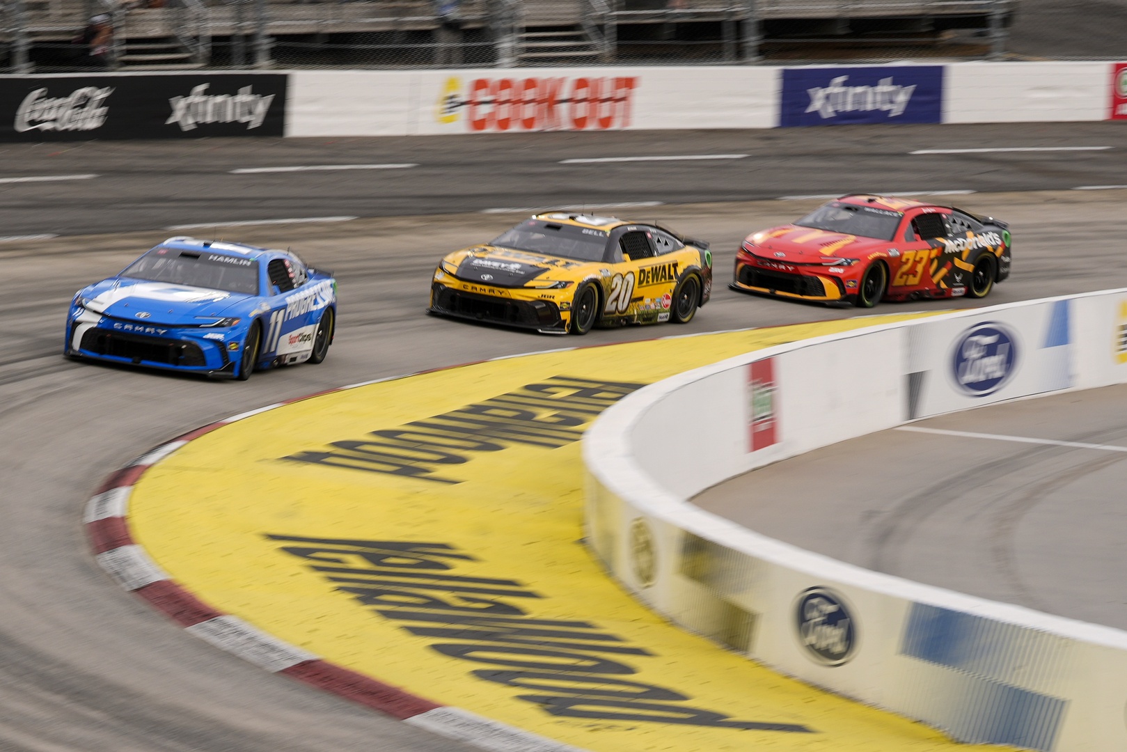 NASCAR Cup Series driver Denny Hamlin (11) leads driver Christopher Bell (20) into turn three during the Cook Out 400 at Martinsville Speedway.