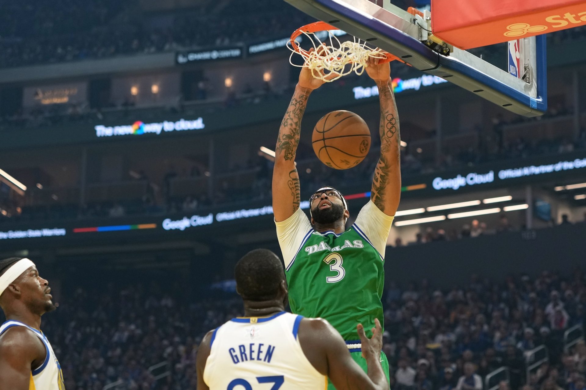 Dallas Mavericks forward Anthony Davis (3) dunks against Golden State Warriors forward Draymond Green (center bottom)) during the first quarter at Chase Center.