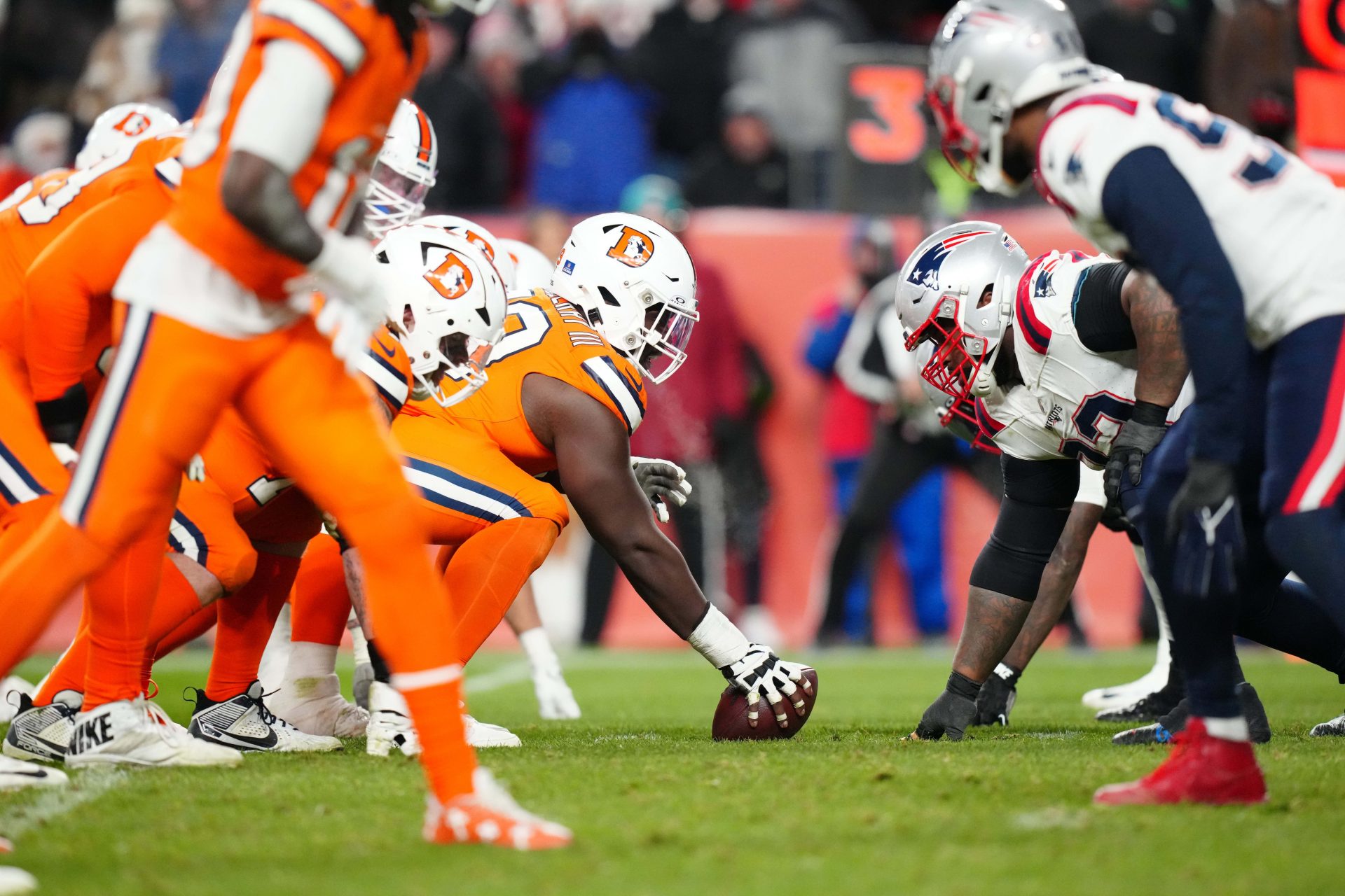 Members of the New England Patriots line up across from the Denver Broncos in the fourth quarter at Empower Field at Mile High.