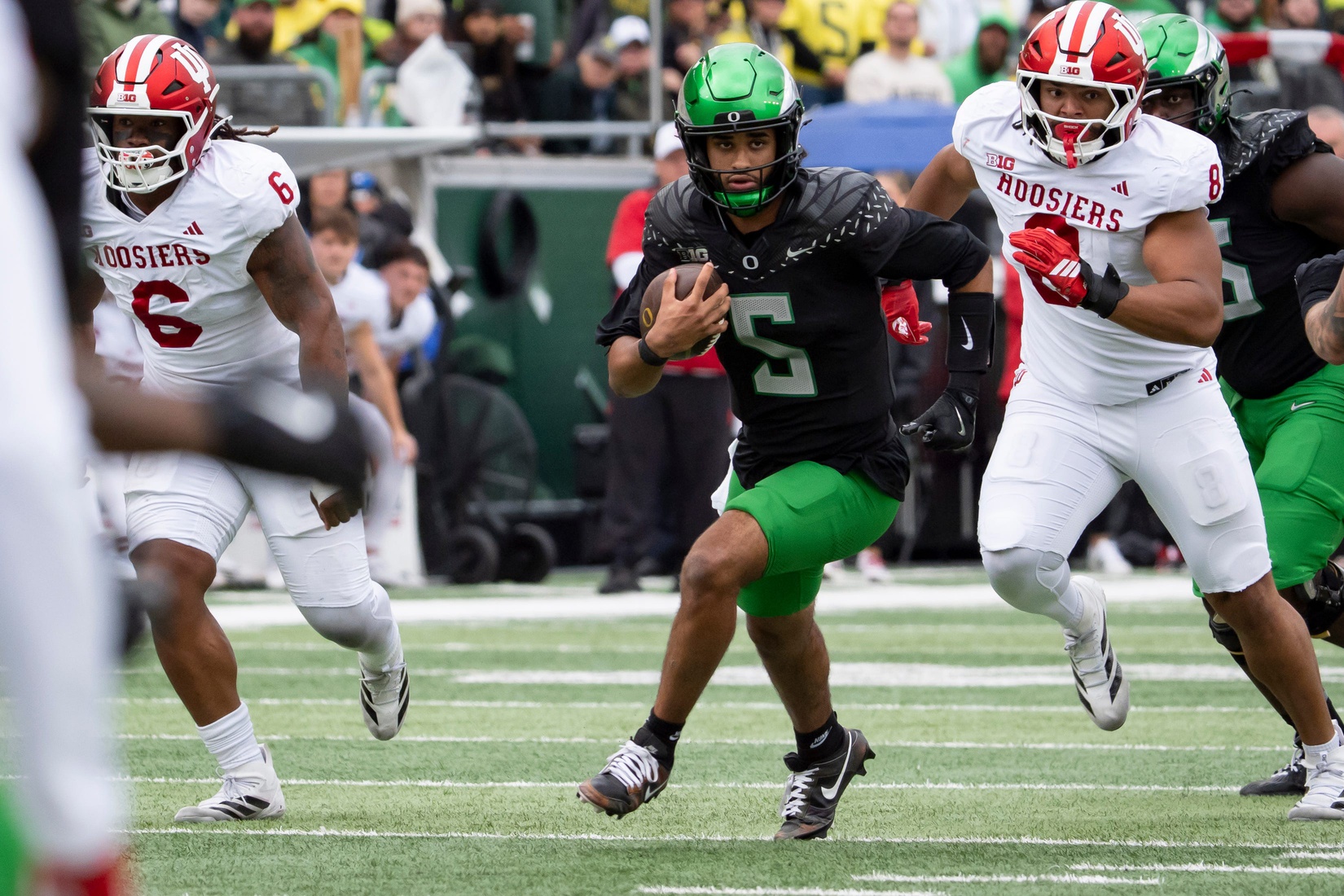 Oregon quarterback Dante Moore scrambles with the ball as the Oregon Ducks host the Indiana Hoosiers Oct. 11, 2025, at Autzen Stadium in Eugene, Oregon.