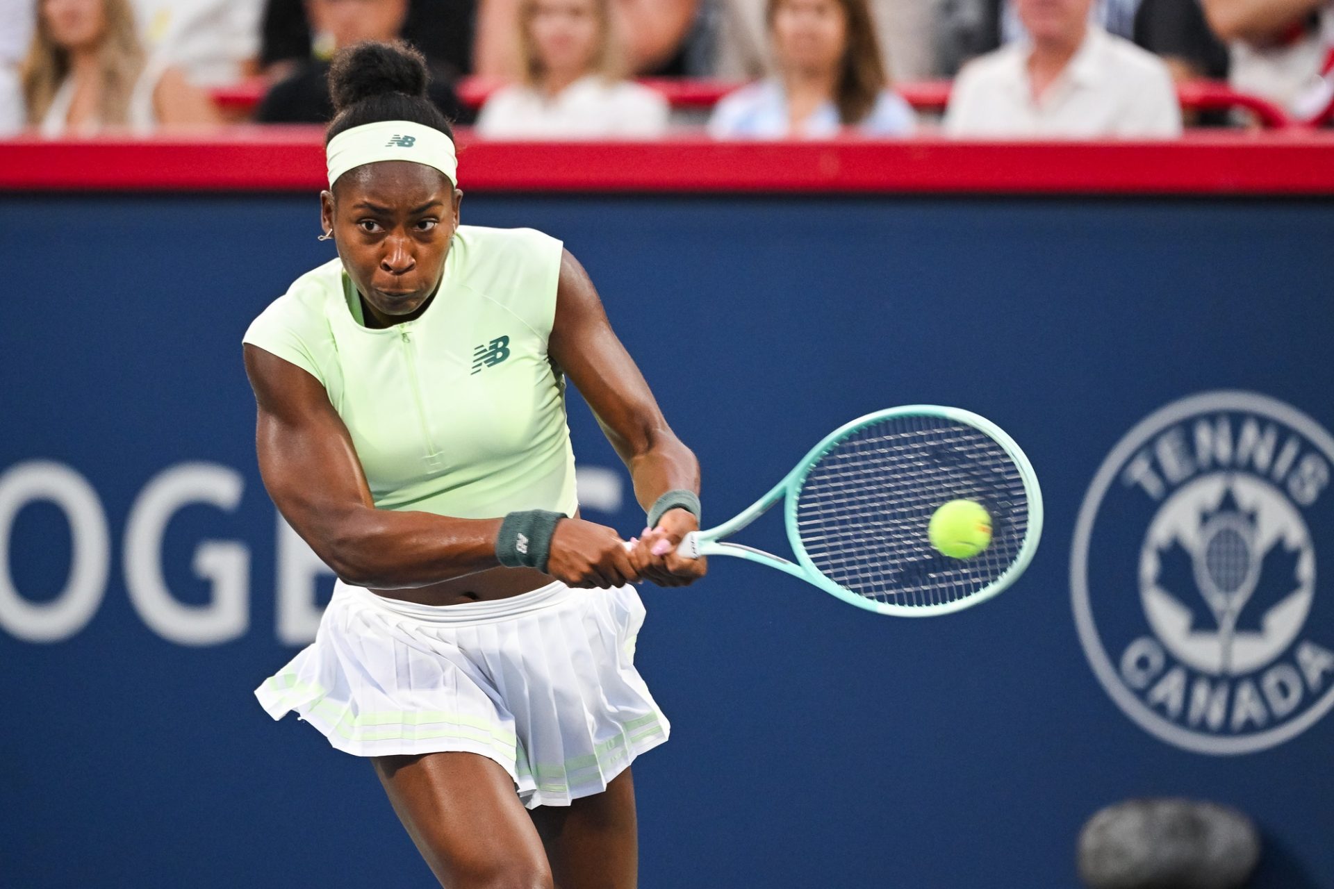 Coco Gauff (USA) returns the ball to Victoria Mboko (CAN) in fourth round play at IGA Stadium.