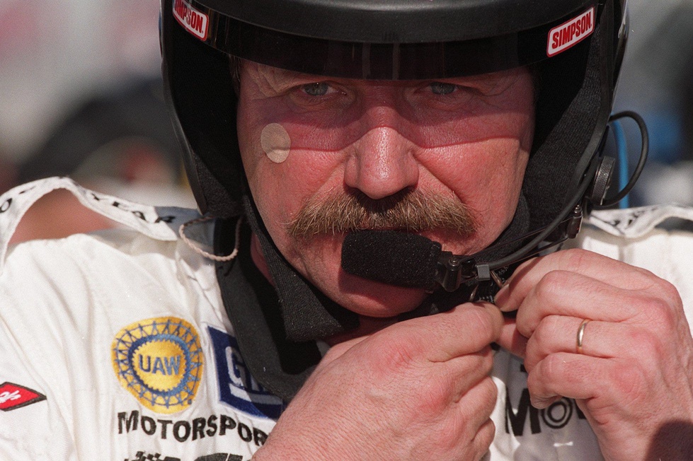 Dale Earnhardt, Sr. adjusts his helmet during testing at the Daytona International Speedway, January 5, 2001.