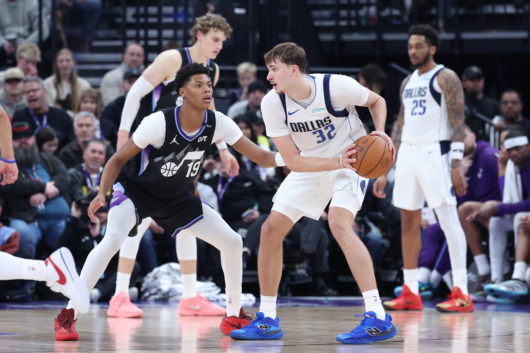 Dallas Mavericks forward Cooper Flagg (32) holds the ball as Utah Jazz guard Ace Bailey (19) defends at Delta Center.