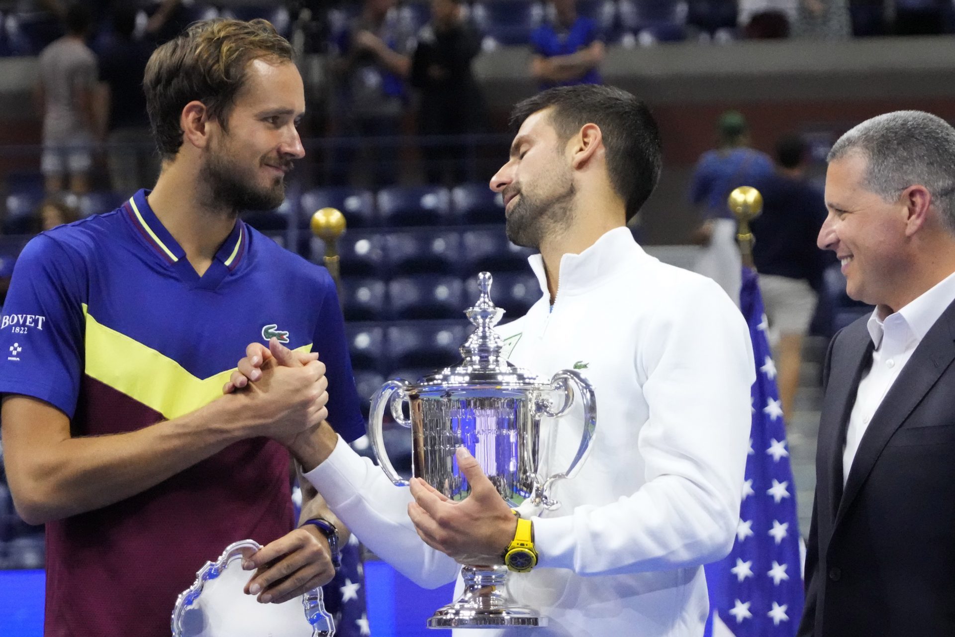 Novak Djokovic of Serbia  (R) shakes hands with Daniil Medvedev (L) during the trophy ceremony after their match in the men's singles final on day fourteen of the 2023 U.S. Open tennis tournament at USTA Billie Jean King National Tennis Center.