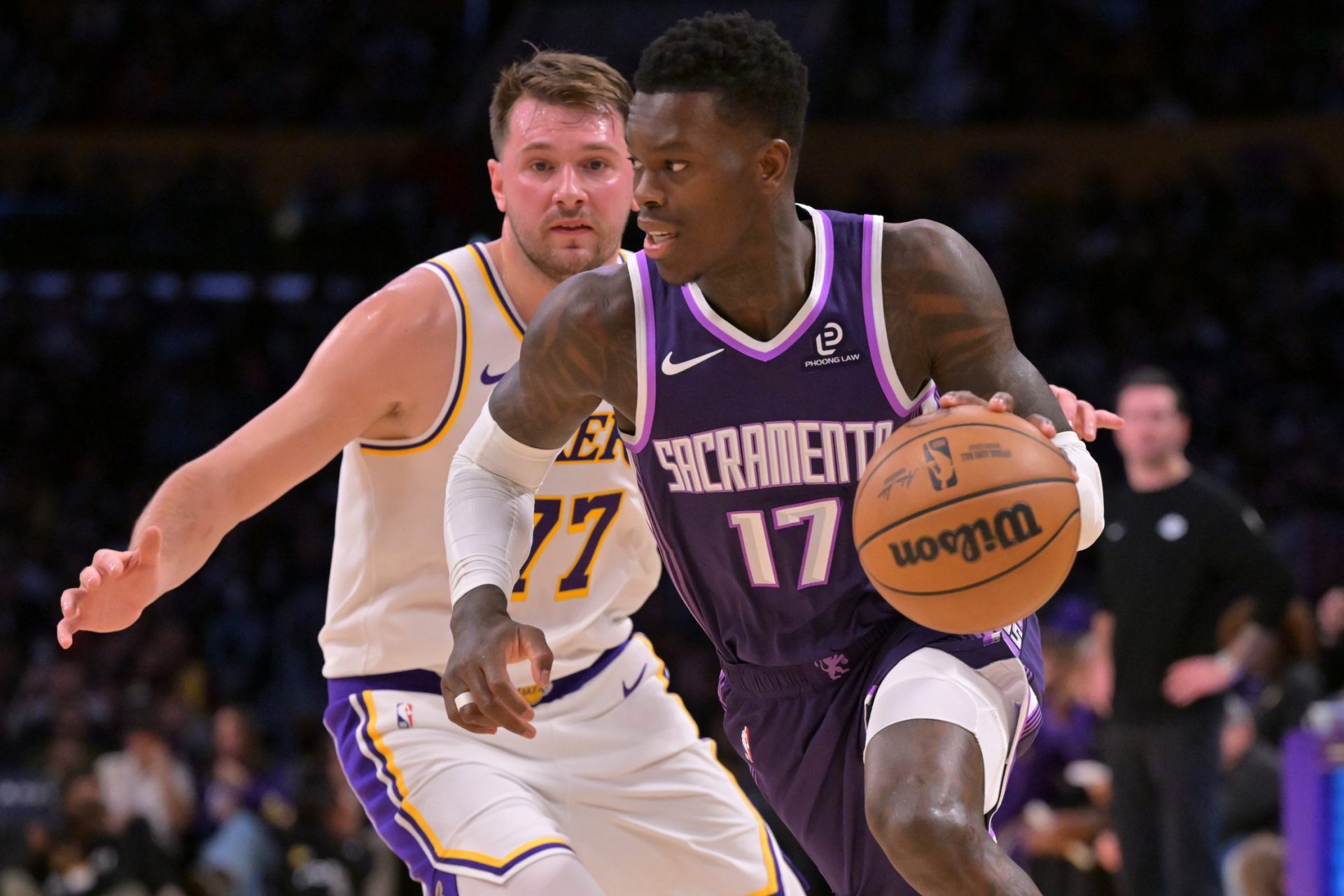 Sacramento Kings guard Dennis Schroder (17) drives past Los Angeles Lakers guard Luka Doncic (77) in the first half at Crypto.com Arena.