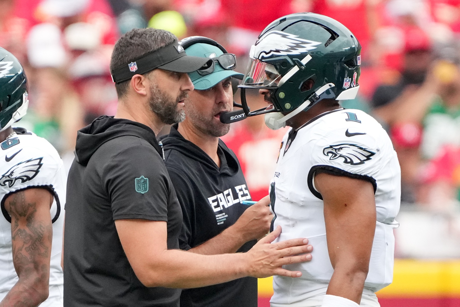 Philadelphia Eagles head coach Nick Sirianni and offenisve coordinator Kevin Patullo speak with Philadelphia Eagles quarterback Jalen Hurts (1) during the second quarter of the game against the Kansas City Chiefs at GEHA Field at Arrowhead Stadium.
