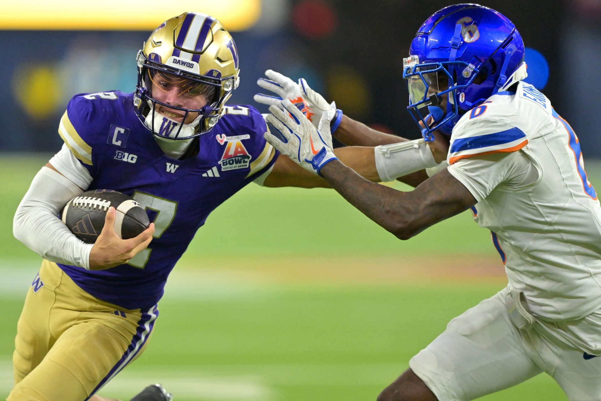 Washington Huskies quarterback Demond Williams Jr. (2) is forced out of bounds by Boise State Broncos defensive back Jeremiah Earby (6) after a catching a pass in the second half of the LA Bowl at SoFi Stadium.