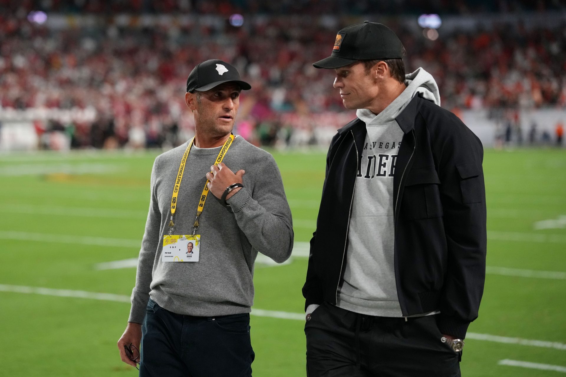 Egon Durban walks on the sideline with Tom Brady before the CFP National Championship college football game between the Indiana Hoosiers and the Miami Hurricanes at Hard Rock Stadium.