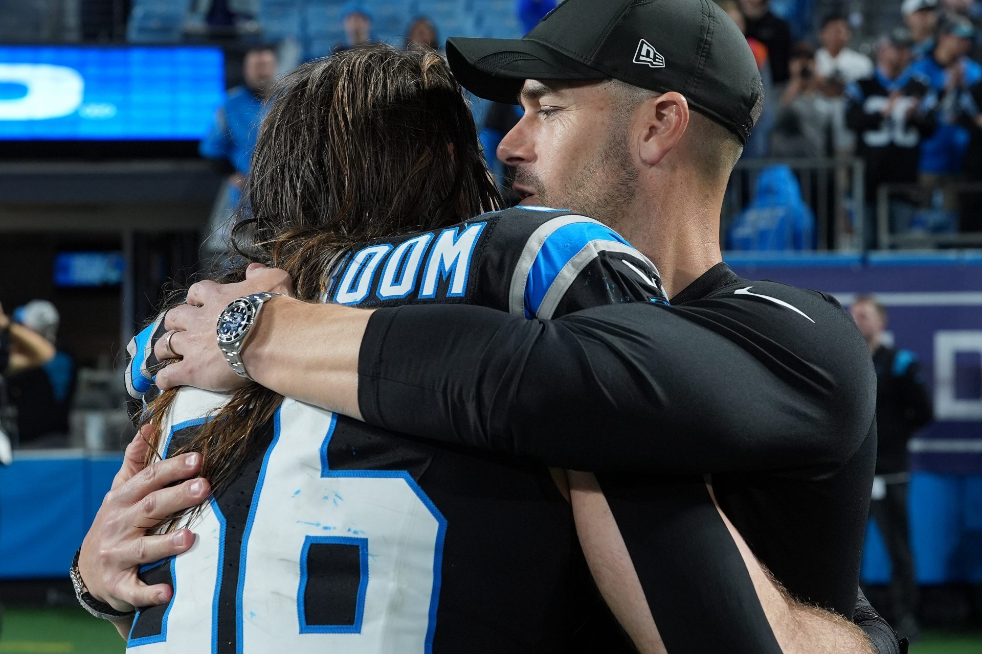 Carolina Panthers head coach Dave Canales and linebacker Christian Rozeboom (56) react after the game in the NFC Wild Card Round game at Bank of America Stadium.